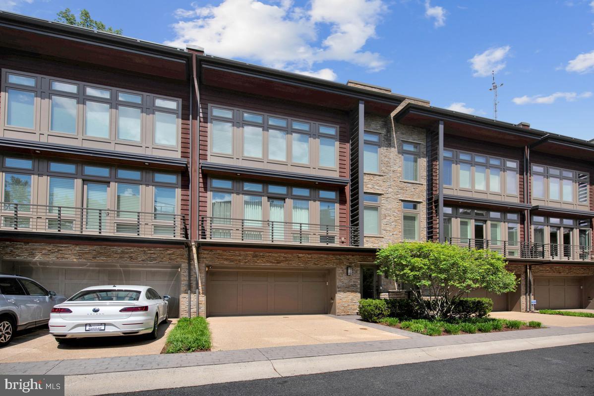 This exciting contemporary townhome incorporates all of the sexy features you would expect - the expansive roof deck with fireplace, kitchenette and built-in gas grill overlooking the Capital Crescent Trail, the open floor plan with a gourmet kitchen open to the living area with a picture perfect view of the patio and treed backing, the luxurious Primary Suite with a soaking tub and roomy shower, an elevator serving all four floors and a two-car garage! The home is in excellent condition and all of the windows have been dressed with expensive blinds (some of them motorized!). The main level has a room that makes a great office but qualifies as a bedroom if so desired.  This small community of townhomes is conveniently near shopping (Whole Foods) and services within walking distance. The close-in location makes for a friendly commute into DC or a short bike ride into thriving downtown Bethesda. And, the rapidly developing Westbard Square is about a mile away with restaurants, shops, Giant Food, Tatte, Starbucks, a Post Office and much more! This is an outstanding opportunity you don't want to miss!