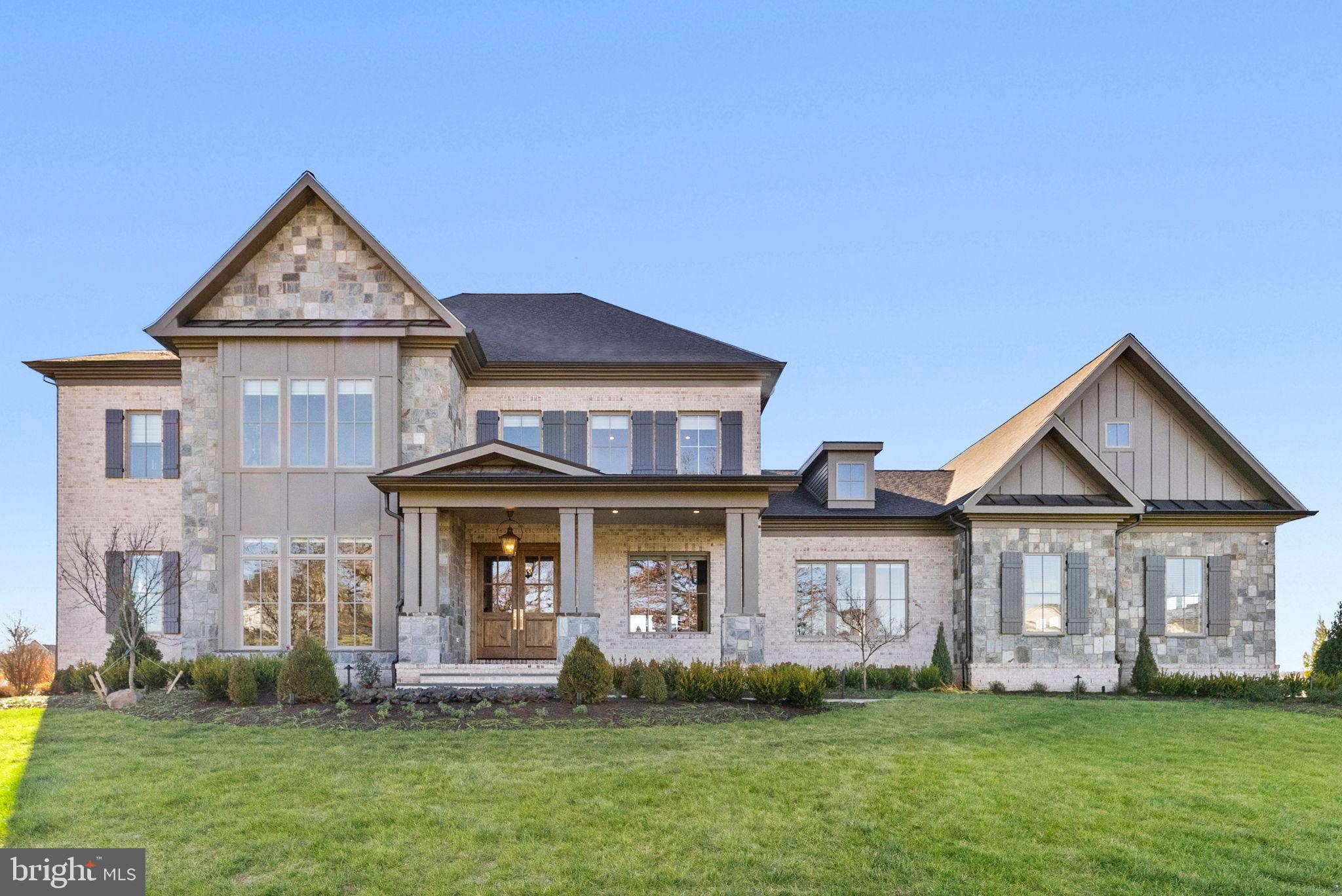 Privately set on a premier 3+ acre homesite behind the gates of the prestigious Creighton Farms Country Club, this newly constructed estate exemplifies transitional elegance, modern sophistication, and master-level craftsmanship—all framed by sweeping mountain views.
Thoughtfully designed from the ground up, the residence welcomes you with a striking stone-and-brick façade, wide-plank hardwood flooring, refined millwork, and impeccably curated finishes. A stately covered entry and spacious three-car side-load garage introduce the elevated living experience found within.
The main level hosts a serene Primary Suite crafted as a true retreat, complete with dual vanities, a soaking tub, and a generous dual-entry walk-in shower. Three fireplaces—located in the Family Room, Primary Suite, and lower-level Recreation Room—bring warmth and ambiance throughout the home.
At its heart, the Gourmet Chef’s Kitchen shines with professional-grade stainless-steel appliances, Quartz countertops, an oversized entertaining island, and both a walk-in scullery (with dishwasher, Sub-Zero beverage fridge, sink, and an additional Wolf oven) and a Butler’s Pantry that services the formal Dining Room. The adjoining Great Room, crowned with an elegant coffered ceiling, opens seamlessly to the covered terrace where panoramic sunsets create a nightly masterpiece. A main-level laundry Room in the primary suite and Mudroom complete this floor.
Upstairs, you’ll find a second Laundry Room, an open Loft/Family Room, and three spacious Bedroom Suites—each with its own private bath.
The expansive, walk-out lower level is designed for recreation and relaxation, featuring a large Recreation Room with a full wet bar (ice maker, beverage fridge, dishwasher), a dedicated Exercise Room, a private Guest Suite with full bath, and abundant storage.
Refined landscape plan featuring curated hardscape, irrigation, and architectural lighting, designed to elevate curb appeal and create a seamless outdoor living experience
**** An exclusive 3-acre parcel lies just beyond the property, retained by the sellers. Though not included in the current sale, this rare opportunity to acquire additional land is available for purchase separately.
Life at Creighton Farms offers more than a home, it provides an unmatched lifestyle within one of the Washington region’s most exclusive private club communities. Anchored by the acclaimed Jack Nicklaus Signature Golf Course, residents enjoy world-class amenities including the state-of-the-art indoor golf facility with heated bays, Har-Tru and USTA tennis courts, a resort-style pool, premium fitness and wellness facilities, and a distinguished Clubhouse offering fine and al-fresco dining, overnight Club Rooms, a Library, Board Room, Golf Shop, and more. Membership options vary and are separate from HOA dues.
Creighton Realty LLC represents the seller in this transaction and does not make any guarantees or warranties regarding the construction, condition, or workmanship of the home. Buyers are encouraged to conduct their own inspections, due diligence, and verification of all information related to the property prior to closing.  Creighton Realty LLC shall not be held responsible for any defects, issues, or conditions related to this property.