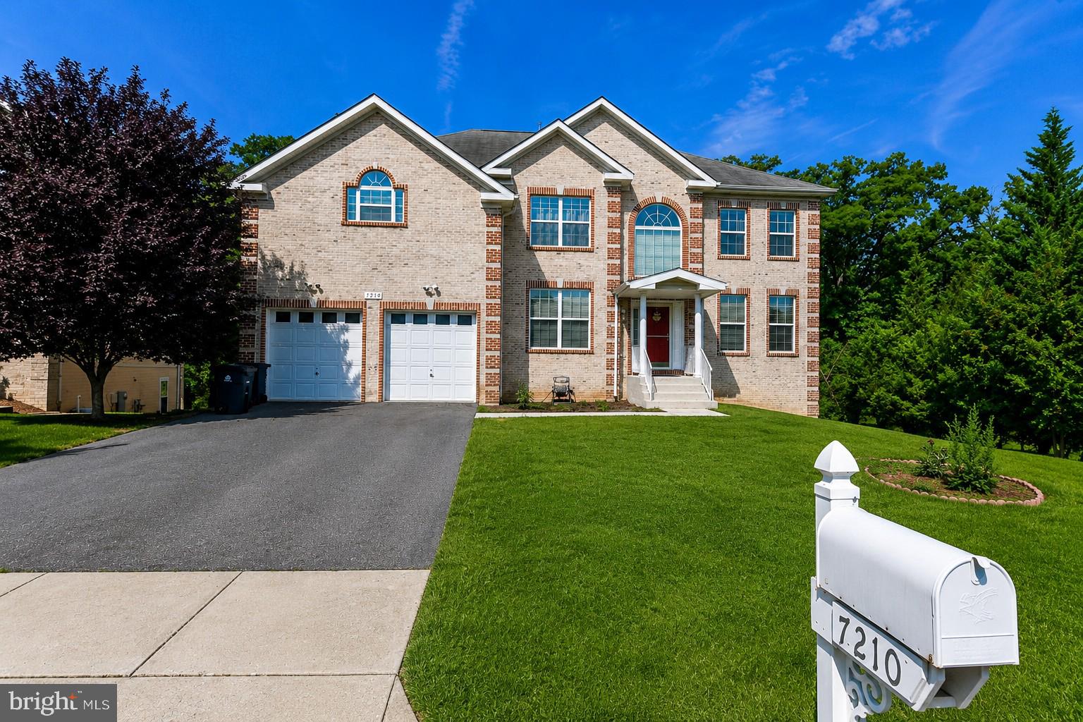 Welcome to 7210 Greenspring Lane, a stunning brick front single-family residence located on a quiet street with a yard that has some beautiful fruit trees and perennial flowers.

Offering over 5,000 square feet of beautifully designed living space. This sun-filled home features 7 spacious bedrooms and 5 full bathrooms, including a convenient main-level bedroom and full bath, ideal for guests or multigenerational living.


The elegant layout includes a formal living room, formal dining room, and a large family room perfect for entertaining. The gourmet kitchen boasts stainless steel appliances, an oversized island, and abundant workspace for gatherings of any size.


Enjoy hardwood flooring throughout the main and upper levels, ceiling fans in multiple rooms, generous storage throughout the home, and several walk-in closets. The luxurious primary suite features two walk-in closets and a spa-inspired retreat.


One of the home’s most exceptional features is its privacy. The backyard overlooks a serene wooded area, while the side of the property faces open green space, creating a peaceful setting rarely found in suburban living.


The expansive, fully finished walkout basement offers tremendous flexibility with an additional bedroom, bonus room, full bathroom, and large recreation space.


Outside, enjoy the fenced yard, attached two-car garage, and parking for four additional vehicles. Combining space, elegance, privacy, and functionality, this remarkable residence is a rare opportunity in sought-after Lanham.