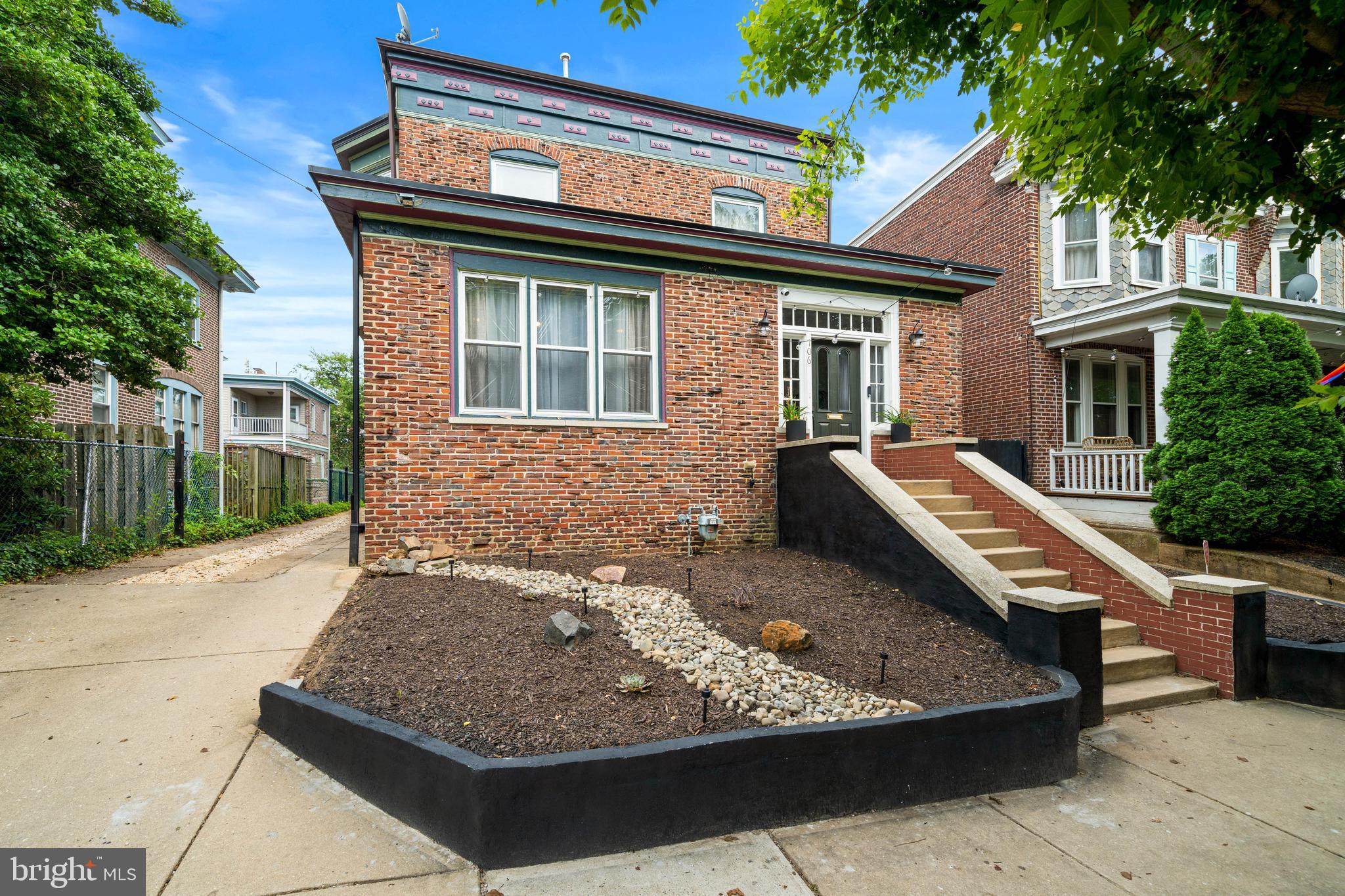 Located in Wilmington’s highly desirable Cool Spring neighborhood, just blocks from Trolley Square, this exceptional 1920s Colonial Revival residence offers a rare opportunity to own a home of remarkable architectural integrity, where the current owner has carefully restored and preserved much of its original character.
A welcoming enclosed vestibule with original red quarry tile sets the tone for the home’s timeless character and scale. French doors  open to a spacious reception hall and elegant formal living room with fireplace, flowing seamlessly into the dining room, currently utilized as a family room. A distinctive architectural highlight is the opening between the dining and kitchen areas, accented by original trim and a stained-glass —once a butler’s pantry or serving passage—now serving as a striking focal point that preserves its historic detail while accommodating modern use. The spacious kitchen has been thoughtfully updated over time and features stainless steel appliances and granite countertops, flowing seamlessly into the morning room with access to a private deck and backyard, complete with a newly added pergola for outdoor enjoyment.
Throughout the home, original transom windows, divided-light French doors, rich hardwood floors, wide Craftsman-style millwork, and period hardware reflect the craftsmanship and intention of early 20th-century design.
A central staircase leads to the second floor, where the spacious primary suite includes an en suite bath, walk-in closet, and adjoining office/dressing room. Two additional bedrooms, a full hall bath, and a large laundry room complete this level. The third floor offers a fourth bedroom with views of the downtown Wilmington skyline. Unique architectural surprises throughout, further enhance the home’s charm, including a hidden staircase, a cozy reading nook built into the stair wall, and a tucked-away bonus space beneath the stairs that provides flexible use as storage, a creative retreat, or quiet workspace. The furnace, AC, and metal roof have all been replaced within the past two years.

Just steps from the revitalized Rodney Reservoir—offering scenic walking paths, community events, and private garden plots—this location delivers an exceptional lifestyle. Enjoy nearby tennis and pickleball courts, along with local favorites such as BrewHaHa, The Coterie, and the highly anticipated Café Karma, plus an expanding mix of neighborhood shops and dining.

Ideally positioned for walkability and convenience, the home is minutes from parks, restaurants, shopping, and nightlife in Trolley Square and the Forty Acres neighborhood, as well as highly regarded private schools including Padua and Ursuline Academy. Commuters will appreciate quick access to I-95, downtown Wilmington, the Riverfront, Amtrak, and under 30 minutes to Philadelphia International Airport, Christiana Hospital, the University of Delaware, and Christiana Mall.

North Rodney Street has long retained its historic charm, and 706 N Rodney continues that legacy—offering enduring character, architectural significance, and lasting value in one of Wilmington’s most established neighborhoods.