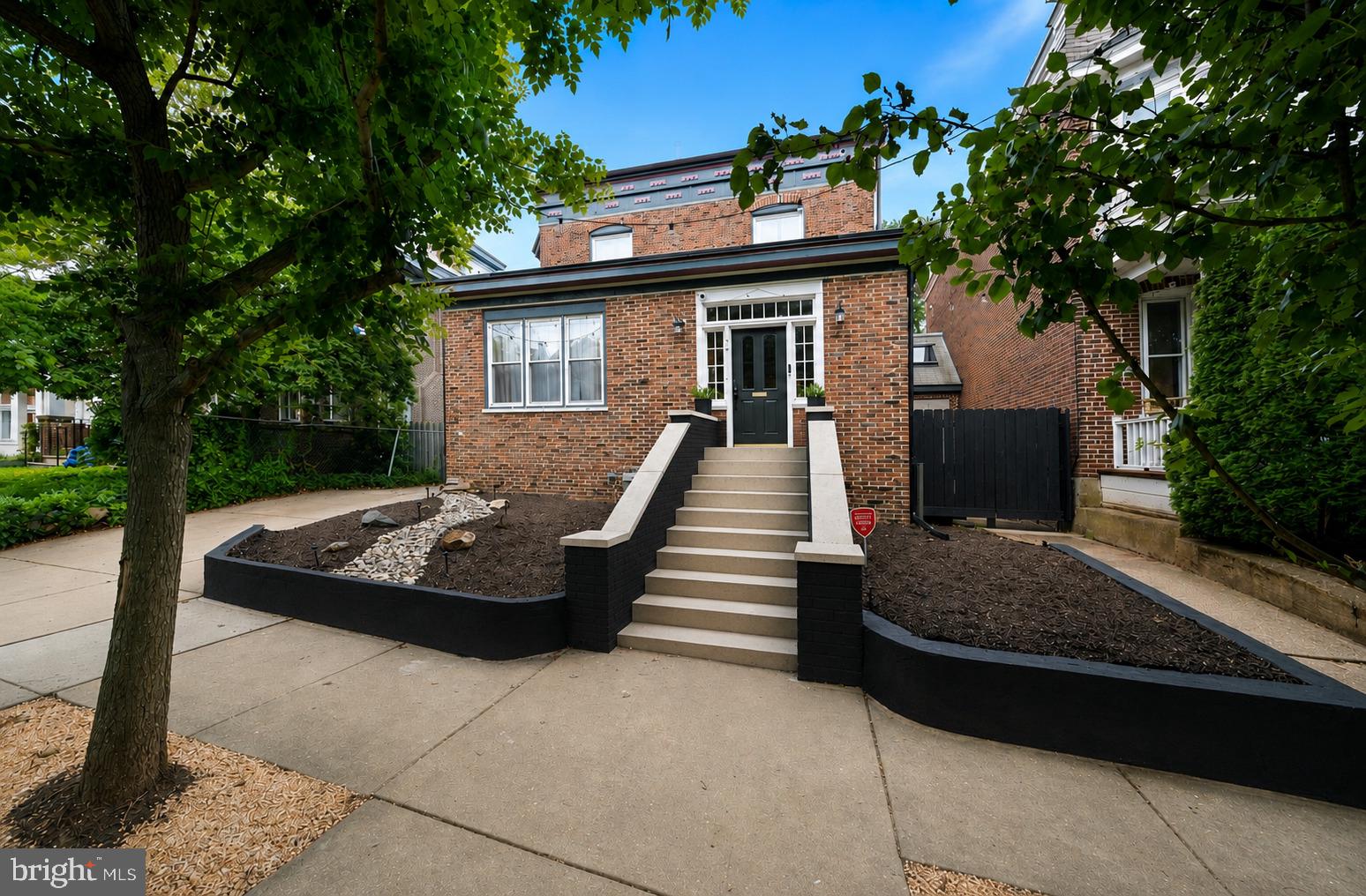 Located in Wilmington’s highly desirable Cool Spring neighborhood, just blocks from Trolley Square, this exceptional 1920s Colonial Revival residence offers a rare opportunity to own a home of remarkable architectural integrity, where the current owner has carefully restored and preserved much of its original character.
A welcoming enclosed vestibule with original red quarry tile sets the tone for the home’s timeless character and scale. French doors  open to a spacious reception hall and elegant formal living room with fireplace, flowing seamlessly into the dining room, currently utilized as a family room. A distinctive architectural highlight is the opening between the dining and kitchen areas, accented by original trim and a stained-glass —once a butler’s pantry or serving passage—now serving as a striking focal point that preserves its historic detail while accommodating modern use. The spacious kitchen has been thoughtfully updated over time and features stainless steel appliances and granite countertops, flowing seamlessly into the morning room with access to a private deck and backyard, complete with a newly added pergola for outdoor enjoyment.
Throughout the home, original transom windows, divided-light French doors, rich hardwood floors, wide Craftsman-style millwork, and period hardware reflect the craftsmanship and intention of early 20th-century design.
A central staircase leads to the second floor, where the spacious primary suite includes an en suite bath, walk-in closet, and adjoining office/dressing room. Two additional bedrooms, a full hall bath, and a large laundry room complete this level. The third floor offers a fourth bedroom with views of the downtown Wilmington skyline. Unique architectural surprises throughout, further enhance the home’s charm, including a hidden staircase, a cozy reading nook built into the stair wall, and a tucked-away bonus space beneath the stairs that provides flexible use as storage, a creative retreat, or quiet workspace. The furnace, AC, and metal roof have all been replaced within the past two years.

Just steps from the revitalized Rodney Reservoir—offering scenic walking paths, community events, and private garden plots—this location delivers an exceptional lifestyle. Enjoy nearby tennis and pickleball courts, along with local favorites such as BrewHaHa, The Coterie, and the highly anticipated Café Karma, plus an expanding mix of neighborhood shops and dining.

Ideally positioned for walkability and convenience, the home is minutes from parks, restaurants, shopping, and nightlife in Trolley Square and the Forty Acres neighborhood, as well as highly regarded private schools including Padua and Ursuline Academy. Commuters will appreciate quick access to I-95, downtown Wilmington, the Riverfront, Amtrak, and under 30 minutes to Philadelphia International Airport, Christiana Hospital, the University of Delaware, and Christiana Mall.

North Rodney Street has long retained its historic charm, and 706 N Rodney continues that legacy—offering enduring character, architectural significance, and lasting value in one of Wilmington’s most established neighborhoods.
