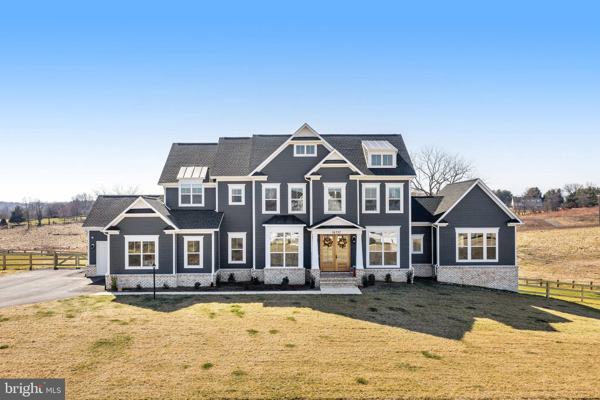 Elegant Living Redefined: The Glen Springs Grand Model at Ivandale Farm. Discover the pinnacle of luxury in this Glen Springs Grand Model by Carrington Homes, completed in September 2023. No need to wait for your dream home to be finished! Nestled on a generous 2 acre homesite in the peaceful Western Loudoun countryside of Ivandale Farm, this stunning property combines serene rural charm with convenient access to Route 7, Leesburg, and key commuting routes. Featuring an impressive 7,013 square feet of sophisticated living space, this home boasts all-around HardiPlank Siding, Double Mahogany Doors, and a 3-car garage. Inside, five bedrooms and 6.5 baths, including a deluxe In-Law Suite, offer ample space for family and guests. The heart of the home is a gourmet kitchen equipped with high-end Kitchen Aid Appliances, surrounded by hardwood floors, coffered ceilings in the family room, and elegant built-ins throughout. The deluxe primary suite serves as a private retreat, complete with vaulted ceilings, Palladian windows, and a luxurious bath featuring a plinth tub and frameless glass shower. Entertainment and leisure are seamlessly integrated with a side clubroom, extended rec room, game room/gym, and an outdoor oasis comprising a covered deck, screened-in porch, and an open-air deck. The Glen Springs Grand Model is more than just a home—it's a lifestyle offering unmatched luxury, comfort, and elegance. Perfect for those seeking sophistication and tranquility, this property invites you to experience the best of both worlds.