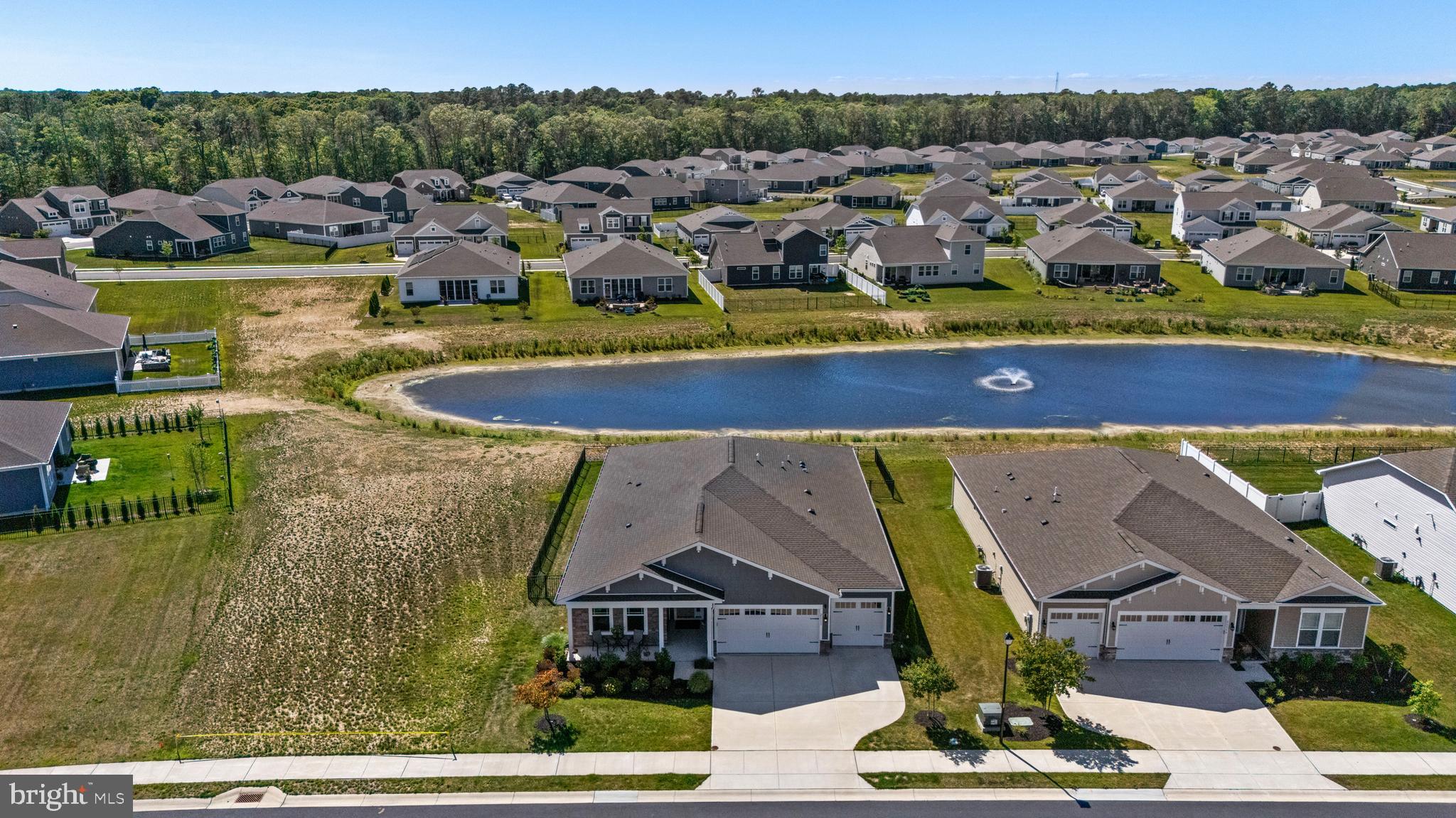 You won’t want to miss this beautiful Wheaton model home located on a premium Pond View lot in Headwater Cove, Lewes, DE.  Headwater Cove is centrally located between Rehoboth and Lewes beaches and just minutes to the beach. This home has been wonderfully maintained and is a Move-In Ready ranch style home providing single level living at its finest with over 2,541 sq ft, 3 Bedrooms, 3.5 baths, a flex room and a 3-car garage. Upon entry you will notice the inviting foyer with tray ceilings leading to two guest bedrooms and a guest bath with luxury vinyl plank flooring thought the home. The flex room is a versatile space perfect for an office or possible 4th Bedroom.  This open floorplan provides ample natural lighting with the Kitchen, Dining and Family room all open to one another. The gourmet kitchen boasts quartz countertops, 5 burner gas cooktop with vent hood, wall ovens, ceramic backsplash, under cabinet lighting and an island/breakfast bar, very large pantry and overlooks a large dining room. The family room features a beautiful tray ceiling and leads to the main bedroom. The main bedroom is spacious with large his and hers closets, tray ceiling and a spa like en suite bath. There is also a large laundry room with full sized washer and dryer. You will find plenty of storage available in the 3-car garage recently upgraded with spackled and painted walls and epoxy flooring. Enjoy entertaining in the enclosed 3 season room leading to the fenced and irrigated rear yard overlooking the community pond. Headwater Cove provides resort style living including a large beautiful outdoor pool, clubhouse, gym, firepit, and sports courts. Close to the beaches, marinas, award winning golf links, restaurants and eateries.