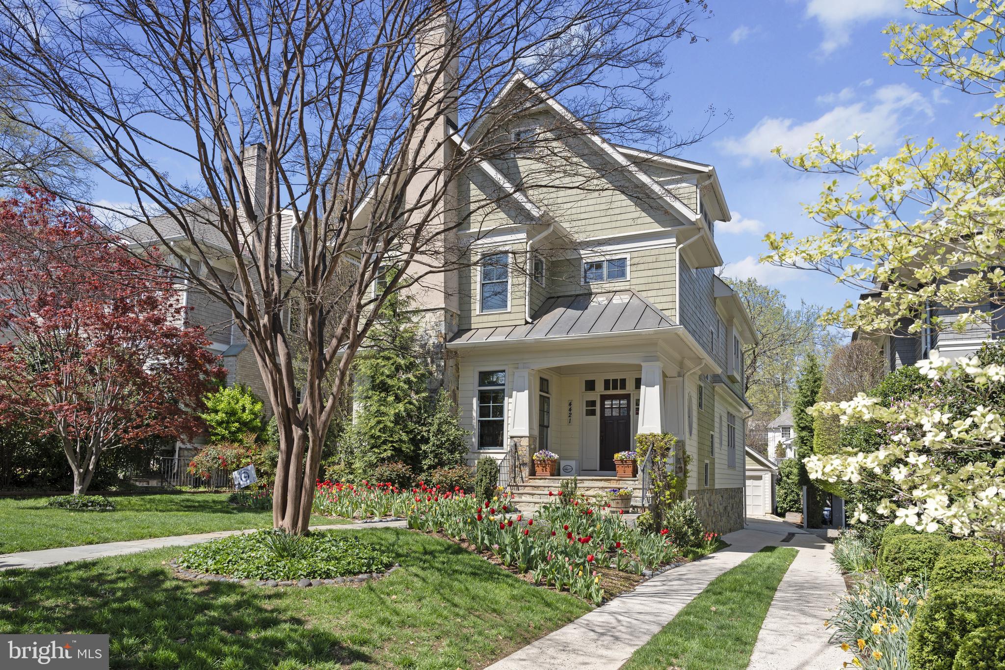 Prominently sited on a level lot in prime Wesley Heights, 4421 Lowell St NW debuts a stunning Craftsman style residence of incredible scale and timeless design to offer the pinnacle of suburban living in a coveted and convenient Northwest DC neighborhood. Boasting 6 Bedrooms and 5.5 Bathrooms across 4 fully finished levels and 7,050 total square feet, every inch of this urban haven effortlessly blends modern convenience with ageless charm. Soaring 10’ ceilings grace the Main Level’s open-concept design, highlighting the expanse of the home’s entertaining spaces. The Living and Dining Rooms, Gourmet Kitchen, and the comfort of the Family Room with its gas fireplace. Walls of windows and a walkout rear Deck overlook a fully fenced and perfectly level rear lawn, adorned with lush gardens. Curated with everyday ease in mind, an elevator services all levels of this magnificent offering. The Second Level hosts 4 of the home’s private suites, to include a sprawling owner’s oasis. The Primary Suite is perfectly appointed to overlook the home’s enchanting gardens and features 2 generous walk-in closets, and a spa-like Primary Bathroom with dual vanity, soaking tub, stall shower, and separate water closet. A conveniently curated Laundry Room and 2 additional Full Bathrooms complete the Second Level’s offerings. Vaulted ceilings span a 5th ensuite Bedroom and adjacent Sitting Room on the Third Level, adding height to already spacious living quarters. A multifunctional Lower Level lends customizable space to fit the lucky new owner’s needs. Boasting a large Recreation Room, Exercise Room, soundproofed Music Room, walkout access to the Rear Yard, and an ensuite 6th Bedroom, this level offers a blank canvas to make your own. A 1-Car Detached Garage and additional driveway parking amplify the numerous urban amenities and conveniences on display throughout the spectacular home. Located in close proximity to the shops and dining destinations of New Mexico Avenue, Battery Kemble Park, Glover Archbold Park, and Wesley Heights Trail, this Wesley Heights gem is sited in a priceless locale.