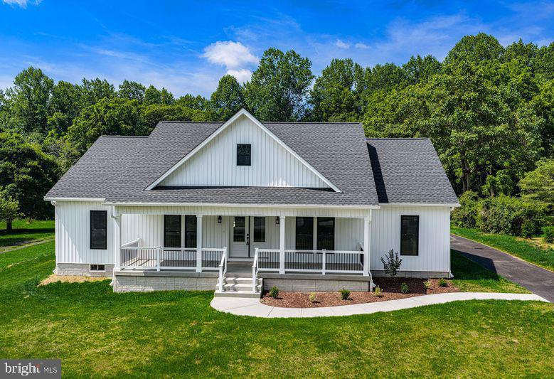 NEW CONSTRUCTION 3 BEDROOM/2.5 BATH CRAFTSMAN STYLE RANCHER IS BEAUTIFULLY APPOINTED WITH 8" WIDTH WHITE OAK LUXURY VINYL PLANK FLOORING, OPEN FLOOR PLAN, AND VAULTED CEILING. CRISP WHITE SIDING WITH A COVERED FRONT PORCH  IS WELCOMING. GREAT ROOM HAS A GAS FIREPLACE WITH STONE SURROUND, WOOD MANTLE, AND SHIP LAP.  GOURMET KITCHEN IS EQUIPPED WITH WHITE SOFT CLOSE SHAKER CABINETRY, SUBWAY TILE BACKSPLASH, CALACATTA  GRAY QUARTZ COUNTERTOPS, STAINLESS APPLIANCES, WALK-IN PANTRY,  EAT-IN TABLE SPACE, AND ISLAND W/SEATING. PRIMARY BEDROOM WITH WALK-IN CUSTOM CLOSET AND SPA-LIKE EN SUITE W/FREE STANDING SOAKING TUB, SHOWER W/SEAMLESS SHOWER DOOR & HEXAGON FLOOR TILES, 2 SEPARATE VANITIES W/CALACATTA GRAY QUARTZ COUNTERTOPS, 12X24 TILE FLOORING,  AND A WATER CLOSET W/POCKET DOOR. 2 ADDITIONAL GOOD SIZED BEDROOMS ARE CONNECTED BY A BUDDY BATH. LAUNDRY ROOM IS SO PRETTY WITH CUSTOM CABINETRY & DEEP BUILT-IN SINK, SHELVING, AND MAYTAG FRONT LOADING WASHER/DRYER. MUDROOM TO 24X24 2 CAR SIDE LOAD GARAGE. CONVENIENT POWDER BATH. 24X16 DECK OVERLOOKS LEVEL BACKYARD BACKING TO TREES.
