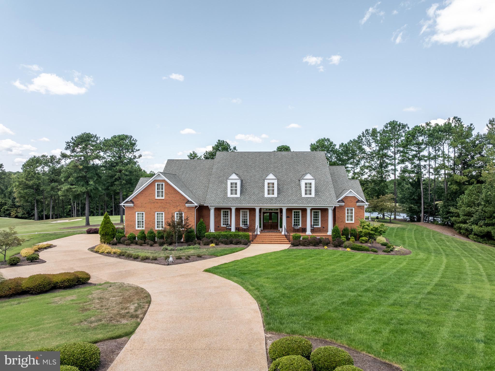 Welcome to this exquisite custom-built estate by Randy Carrington (2007), perfectly situated on a 1-acre golf course lot in Founders Bridge overlooking the 16th and 17th holes of the Independence Golf Course. Lovingly maintained by its original owner, this home combines timeless elegance, thoughtful design, and an unbeatable location. From the moment you enter the grand foyer with soaring two-story ceilings, hardwood floors, and an intricate wood medallion inlay, you’ll be captivated by the craftsmanship and attention to detail throughout. The main level offers formal living and dining rooms with elegant crown molding, wainscoting, and plantation shutters. A private study with built-ins and stone work surface provides the ideal home office. The family room boasts a dramatic two-story ceiling, custom built-ins, gas fireplace with stone surround, and architectural millwork. A charming billiards room with pine floors, wainscoting, and pocket door that leads seamlessly into the chef’s kitchen. The kitchen features two-story ceilings, tile floors, rich cherry cabinetry, abundant cabinet space, stainless steel appliances, a double wall oven, and an eat-up bar that overlooks the family room. A spacious utility room offers washer/dryer, utility sink, and additional cabinetry. The first-floor primary suite is a retreat, featuring a generous sitting area, spa-like en-suite with soaking tub and walk-in shower, and two oversized walk-in closets. Upstairs, find three additional large bedrooms—two connected by a Jack & Jill en-suite and one with its own private bath. A spacious rec/game room features a hallway lined with custom built-ins, perfect for books or games, along with a large closet for extra storage. Enjoy resort-style living in Founders Bridge, home to the award-winning Independence Golf Club, with walking trails, clubhouse, and community amenities—all while coming home to your own private 1-acre lot with golf course views from almost every room in the house.