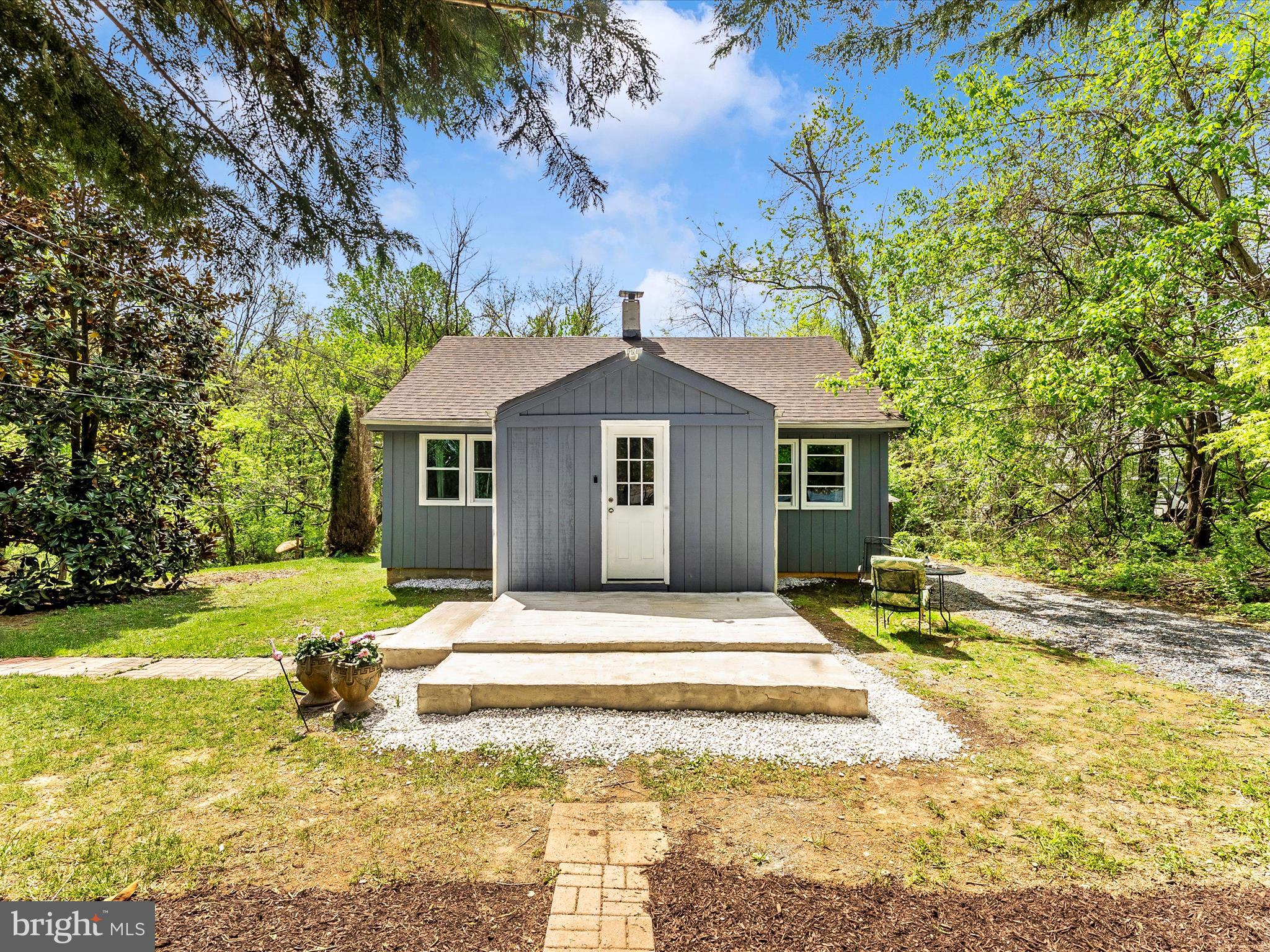 Charming bungalow with a RECORDED 6 BED PERC and approved septic site plan in the Ag Reserve! Rare STARTER HOME in the Poolesville School district with the POTENTIAL TO GROW WITH YOU AND YOUR FAMILY! 1 acre lot buffered and backed by trees on a quiet country road with quick access to State Route 28, I-270, MARC Train, Sugarloaf Mountain, both Monocacy and Potomac Rivers, and everything else the Ag Reserve has to offer. This home features NEW T1-11 siding, roofing, windows, newer HVAC, heat pump (2 years) and ductwork, updated 200 amp electric panel, 300 gallon holding tank with pressure pump, softener, and three stage filtration. Enter through the enclosed porch to an open kitchen/living room combo with rustic hardwood floors and light filled new windows. The kitchen is anchored by a generous island with useful counter space and ample built-in storage. An oversized stainless sink, glass cabinets, and tile flooring compliment the open kitchen space. Additional pantry space and front load washing and drying machines can be found in the laundry room off the back of the kitchen. Two large bedrooms and a full bath with a shower/tub combo complete the main level.  A third room that is being used as storage could easily be converted into a third bedroom. The loft/attic area features shelving for storage and two heat extractors. The crawl space has moisture barrier material over the dirt floor and houses the new water heater, furnace, filtration system, holding tank, and electric panel.