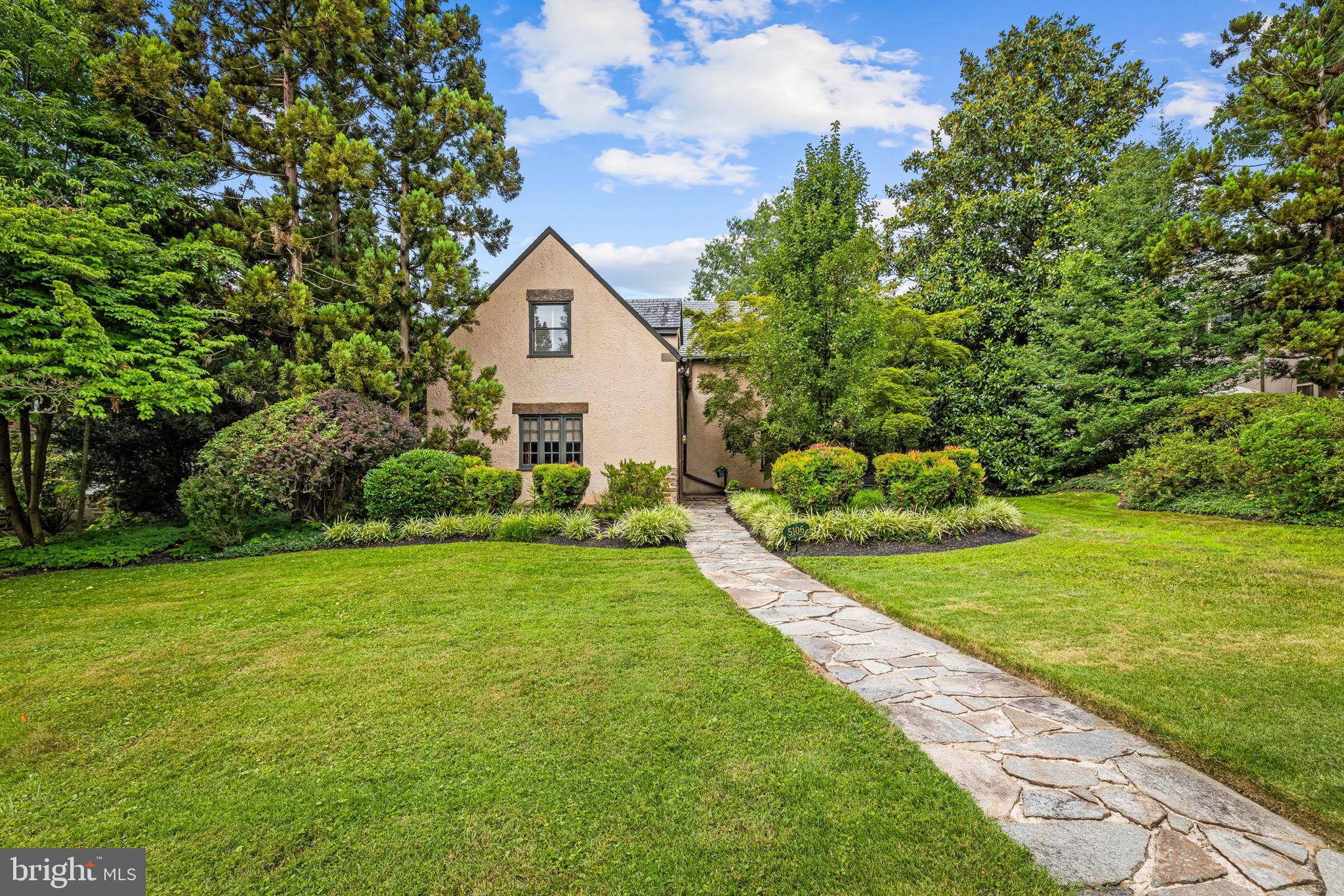 OPEN THURSDAY 12-2PM.  A timeless Tudor Revival residence with French Norman influences, distinguished by its steep slate rooflines, textured stucco exterior, stone architectural accents, and classic divided-light casement windows. 3 bedrooms, 2.5 baths with generous proportions and surprising amount of living spaces including a large dining room, a beautiful living room with stone fireplace, a den/family room and a gourmet eat in kitchen with professional grade appliances. Several French doors on the first floor open to a private awning-covered patio providing shaded space for outdoor entertaining. Upstairs, a spacious primary suite features a separate sitting area/dressing room and ensuite full bath. There are 2 additional bedrooms and a full bath in the hallway. A large, unfinished basement (fully waterproofed) includes multiple storage areas and a laundry room. Detached 1-2 car garage and beautiful front and rear yards.  Seller prefers to sell the home "AS IS" and price is reflective of this.