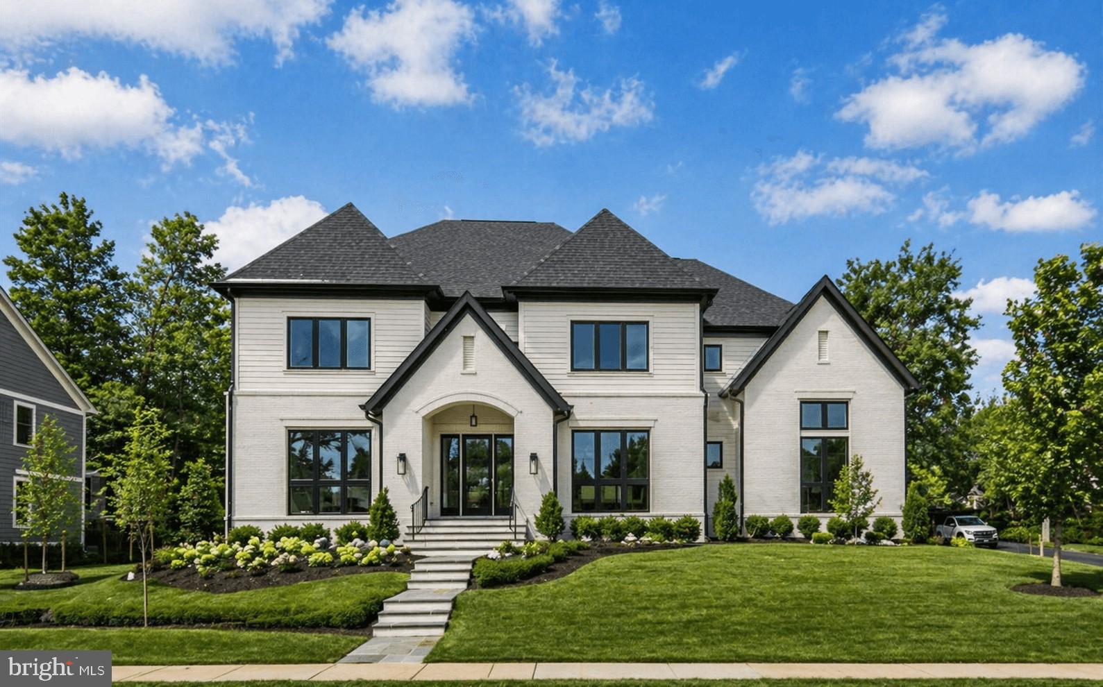 Built by renowned Cherry Hill Custom Homes, this exceptional McLean residence pairs timeless elegance with modern livability in one of Northern Virginia’s most coveted neighborhoods. Thoughtfully designed with over 7,100 square feet across three finished levels, the home is filled with natural light, refined finishes, and beautifully scaled living spaces. Highlights include a dream mudroom with custom built-ins and herringbone tile, wide-plank European White Oak floors, and a stunning chef’s kitchen featuring Sub-Zero and BlueStar appliances, custom cabinetry, quartz countertops, and a butler’s pantry connecting to the formal dining room. The great room opens seamlessly to a screened porch and Virginia Bluestone patio, creating effortless indoor-outdoor living. Upstairs, the luxurious primary suite offers dual custom walk-in closets and a spa-inspired bath with heated marble floors and a soaking tub, alongside three additional ensuite bedrooms and an oversized laundry room with double washers and dryers. The lower level is equally impressive with a recreation room, wet bar, fitness room, guest suite, and optional elevator conversion already built in. Professionally landscaped grounds, a custom privacy fence, sprinkler system, and quiet cul-de-sac setting complete this beautifully curated home just moments from Tysons, top-ranked schools, parks, and downtown D.C.