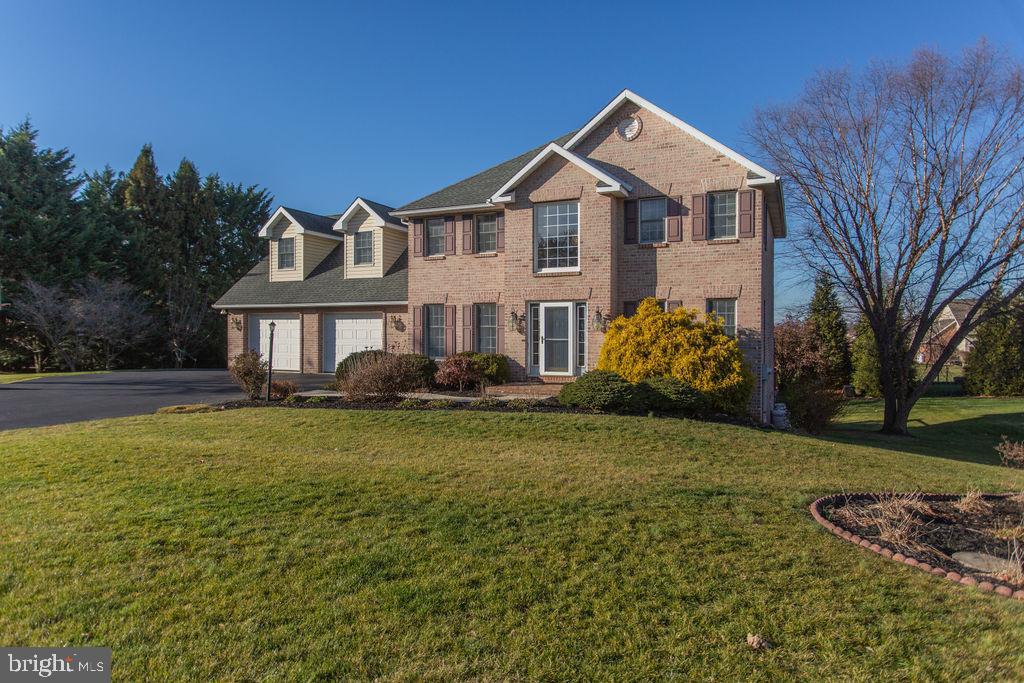 Beautiful brick colonial in Country Lane.  This home boasts a main level family room with wood flooring and a corner gas fireplace, an oak kitchen with bar area, walk-in pantry and breakfast nook, separate formal dining room and formal living room. Five bedrooms including a primary suite with full primary bathroom featuring a soaking tub and separate shower. An additional full bathroom and two half baths. Finished walk-out basement with 16x7 workshop, rear two-tier deck and patio, two car attached garage and mature landscaping. Beautiful views and beautiful sunsets.  Call to schedule your private showing today!