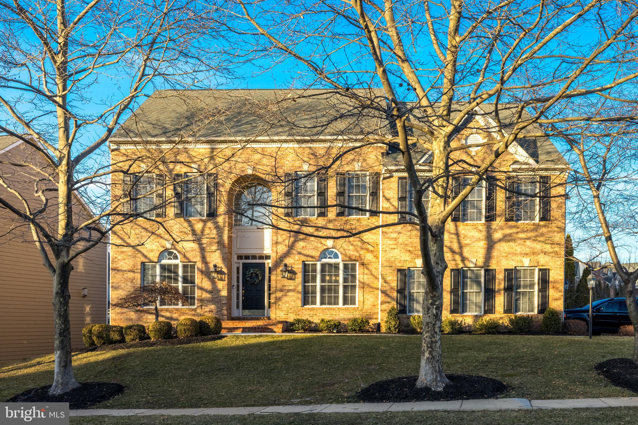 Beautiful brick-front Colonial in the sought-after Lansdowne on the Potomac community combines the best of timeless design, modern updates, and peaceful outdoor living on a quarter-acre lot. Enjoy grand interior proportions and versatile living spaces, plus a recently finished lower level, all just moments from Lansdowne Town Center, top-rated schools, and neighborhood parks. Arrive into the double-height foyer, with hardwood floors leading to formal living and dining rooms ideal for both hosting and everyday relaxation. At the heart of the home, the open-concept kitchen flows into a light and airy two-story family room, where cathedral ceilings soar above large windows and a cozy fireplace. The gourmet kitchen is designed for gathering, featuring a large granite-topped bar, updated stainless steel appliances and tile back splash, abundant cabinet storage, as well as a walk-in pantry. A breakfast nook opens directly to the deck through an updated Pella triple sliding door crafted to resemble French doors to align with the community’s design. The main level also includes a private home office, a powder room, and a laundry room with upgraded front-loaders. Outdoor living is easy with a deck just off the main living areas, and a fenced backyard perfect for pets and play. Upstairs, the primary suite is a private retreat with vaulted ceilings, a spacious sitting area, and a large walk-in closet. The en suite primary bath features a corner soaking tub, double vanity, and shower with dual heads. A junior suite with its own private bath and two additional bedrooms connected by a Jack-and-Jill bathroom are also on this level. The walk-up lower level, finished in 2023, expands your living space with a large den and rec room that opens to the backyard. Two versatile bonus rooms and a chic remodeled en suite bath with oversized shower offer endless possibilities for guests, a home theater, gym and more. Unfinished storage/utility areas add convenience. The upgraded two-car sideload garage features epoxy floors, updated doors and openers (2022), and connects to a driveway repaved in 2021. Additional recent updates include new HVAC (2019), kitchen appliances (2019), garbage disposal (2023), front walkway (2024), and more. Lansdowne on the Potomac is known for its exceptional amenities, including indoor/outdoor pools, fitness facilities, sport courts, playgrounds, meeting spaces, and more. Nearby Route 7 provides easy access to shopping and dining at Lansdowne Town Center, golf courses, hiking trails along the Potomac River at Elizabeth Mills Riverfront Park, and Lansdowne Resort & Spa. With its thoughtful layout, modern updates, and prime location in one of Loudoun County’s most celebrated communities, this one has it all!