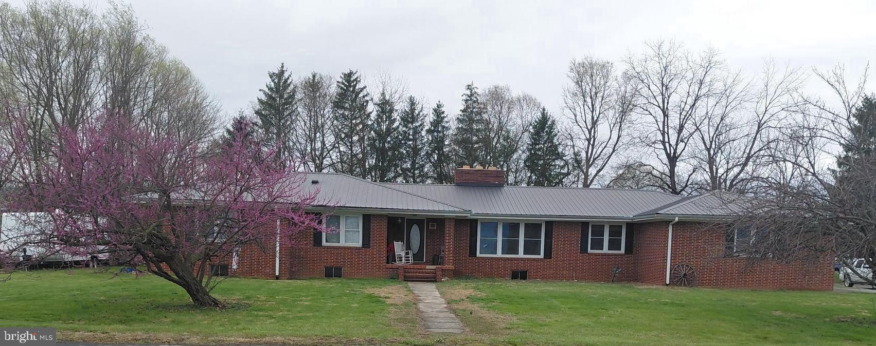 Absolutely stunning large brick home in the quaint and historic town of Petersburg, West Virginia. It is near all the conveniences of this wonderful town yet tucked away in a beautiful area. This well-built home sits on 2.13 acres. It has elegant woodwork, beautiful fireplaces and gorgeous wooden floors. The family room has double doors that open to the patio, where you can enjoy the evenings outside. The large kitchen is ready for you to celebrate any upcoming occasions. It has 4 bedrooms and 2 full baths upstairs, The master bedroom has walk-in closets with an attached full bath. This home provides the ability to live on one floor but offers a beautiful basement that is 75% finished! The basement includes a huge family room with a brick fireplace, a half bath and a bar area. The unfinished portion has plenty of storage for all of your belongings. This house is a true gem. It is also located near many natural wonders like Seneca Rocks, Dolly Sods, Spruce Knob and of course the South Branch of the Potomac River where you can enjoy fishing and kayaking! Call today for a showing!