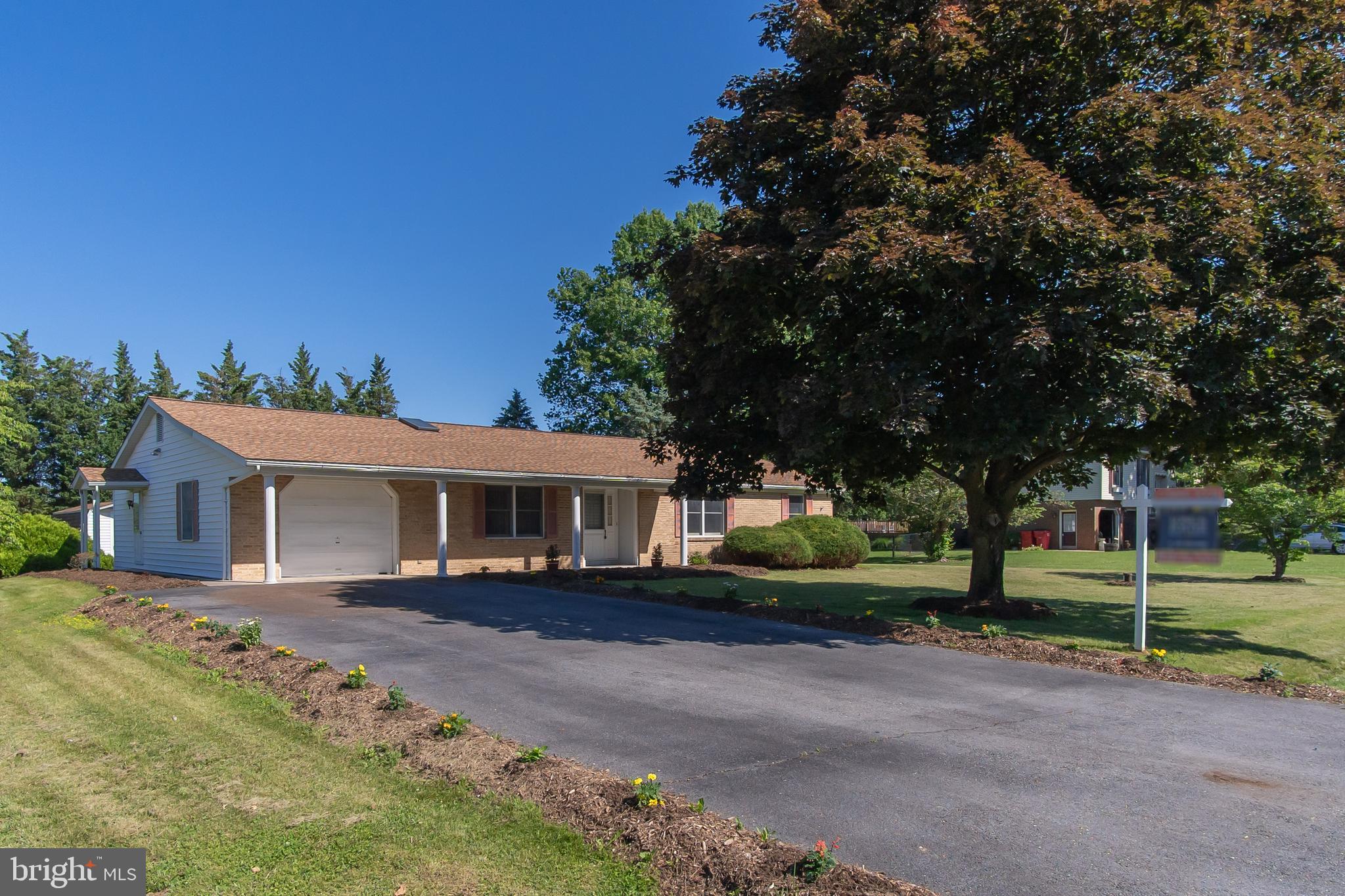 This beautiful brick-front rancher was the neighborhood builder’s original home and has since been impeccably cared for by the same owner for 37 years.  It’s hard to find ONE LEVEL LIVING that includes a living room, family room, formal dining room and 3 bedrooms with a bonus den but here it is - and all on over a half-acre of land in peaceful Williamsport!  The functional floor plan includes 3 full bathrooms and a bright and spacious eat-in kitchen, with lighted ceiling fan, recessed lights and a skylight!  Preparing meals is a breeze with the wall oven, separate cooktop and plenty of cabinetry for kitchen storage.  The cozy family room, accented with decorative ceiling beams, is accessed from the front and back hallways. The formal dining room is the perfect spot for the family to gather with chair rail and crown moldings.  The primary bedroom includes its own en-suite bathroom and walk-in closet while the second and third bedrooms share a hallway bathroom with tub/shower combo and dual sinks.  The den has its own full bathroom, separate door to the outside and access to the deep, one car garage with pull down ladder leading to extra storage space.  The large, flat backyard is everything you’re looking for with a freshly stained deck with built-in bench and a large storage shed.  It’s even tree-lined in the back for added privacy.  Full washer and dryer.  WATER HEATER (2026), HOLDING TANK (2026), ROOF (2022), HVAC (2021).  No HOA! ONE YEAR HOME WARRANTY INCLUDED!