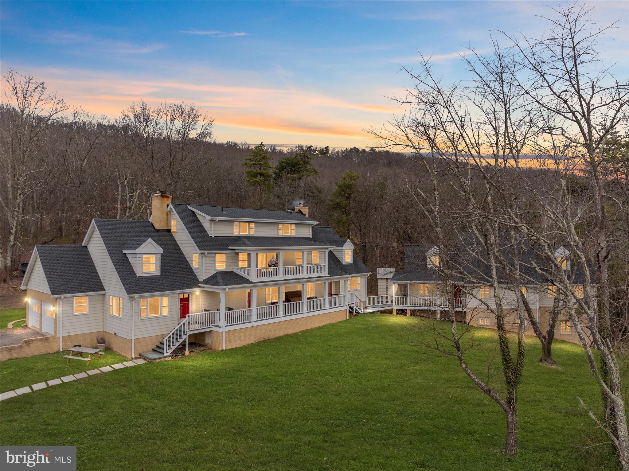 SELLERS ARE MOTIVATED AND HAVE A HOME THEY ARE PURCHASING!   Experience the freedom and privacy of country living at 515 Old Fire Tower Rd in Capon Bridge. Set on 20 acres along a private road, this impressive property offers space, flexibility, and thoughtful upgrades throughout.

The home offers three levels of living space, including 6 bedrooms and 4.5 bathrooms, along with a 2-car garage, providing plenty of room for large households, multi-generational living, or hosting guests. The home has been extensively remodeled and features a new roof with 50-year architectural shingles, updated electric panels (2018), aluminum siding and flashing, and 7 Gbps fiberoptic internet for modern connectivity even in a private country setting.

Inside, the chef-inspired kitchen is designed for both everyday living and entertaining, showcasing custom cabinetry, granite and end-grain oak butcher block countertops, Shaw’s “Lancaster” fireclay sink, Allia French deep fireclay sink, solid brass hardware and pot filler, new wiring and plumbing, two GE Café propane ranges with double ovens (four ovens total), and two dishwashers.

Throughout the home you’ll find a blend of new and original solid oak flooring, durable porcelain thru-body tile, and new Stainmaster PetProtect carpeting with premium padding and moisture barrier. A large laundry room with new washers and a dryer is complemented by a second washer hookup in the utility room for added convenience.

Comfort and character come together with multiple heating options including a Vermont Castings fireplace insert, a wood stove on the second floor, and a coal/wood stove on the first floor, allowing the home to be heated with wood or coal if desired. Two full brick chimneys add both charm and function.

Beyond the home, the property truly shines with a detached Industrial Office/lab/workshop offering  3,500 square feet. The building is wired to accommodate three 200-amp breakers, providing incredible flexibility for future commercial use (veterinary clinic, office space, lab, storage), serious hobbyists, or a large-scale workshop. It could also be transformed into an impressive guest house, studio, or recreational space, depending on your vision.

Outside, enjoy two porches overlooking peaceful surroundings filled with wild blueberries and a variety of fruit trees, including apple, peach, cherry, and pear. With open space, wooded areas, and a chicken coop already in place, the land is ideal for gardening, homesteading, outdoor recreation, or simply enjoying the quiet beauty of the countryside.

This one-of-a-kind property combines size, privacy, modern upgrades, and exceptional versatility—a rare opportunity for those seeking space to live, work, and create in the scenic hills of West Virginia.