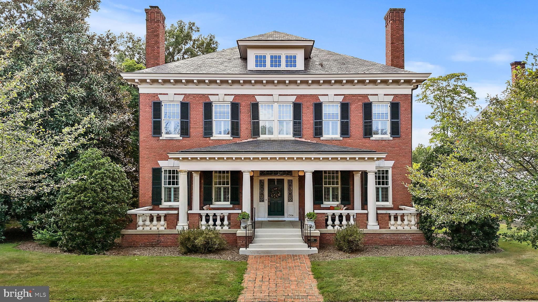 A rare opportunity to "Live on the Avenue" in one of downtown Fredericksburg's finest and most distinguished homes. Originally built in 1910 and meticulously rebuilt in 2001, this home blends historic charm with modern convenience.
Inside, grand hallways, soaring ceilings, rich hardwood floors and elegant dentil crown moldings create an immediate feeling of the quality you'll enjoy throughout. The chef’s kitchen features a new Forno eight-burner range with double oven (2024), a full refrigerator (2025), and a Subzero two-drawer freezer. The adjacent hearth room, with a cozy fireplace and floor-to-ceiling windows, offers stunning views of downtown and the University of Mary Washington.
Four levels of living space are easily accessible via an elevator. The primary bedroom features a private balcony and spa-like en-suite. Two additional bedrooms have en-suite baths, and a partially finished basement offers entertainment space and storage.
Set on 0.89 acres, the home features lush landscaping and a spacious front porch. Updates include a five-zone HVAC (2024), renovated built-in gutters (2024), exterior paint (2024), and Trex decking (2024). A timeless estate in a prime location—don’t miss this rare find.