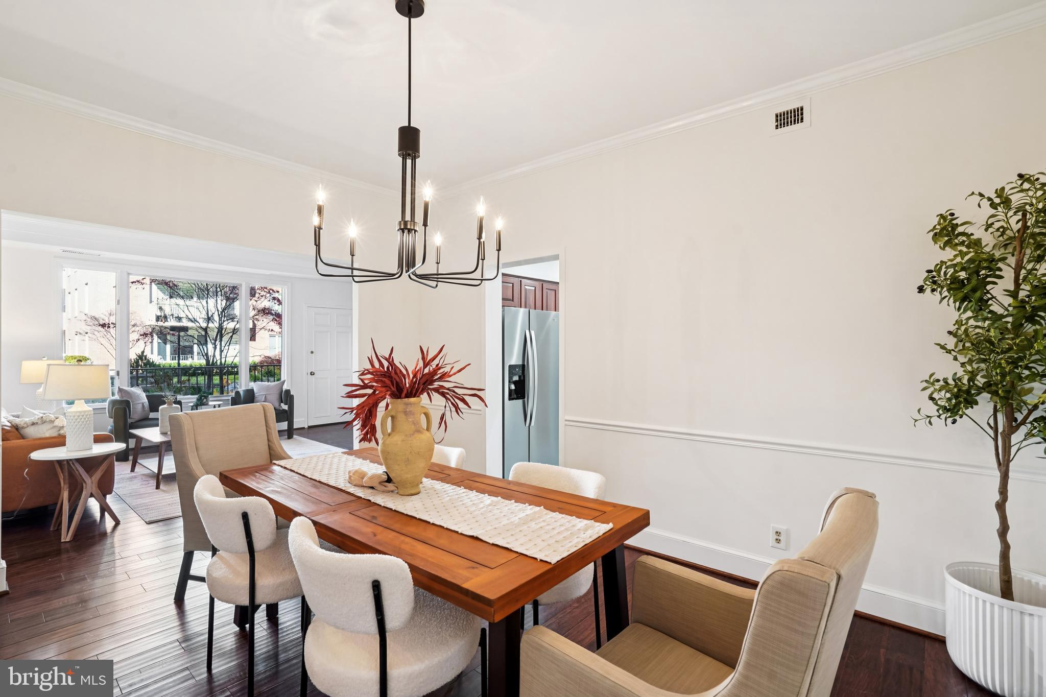 PRICE REDUCED! Welcome to this sun filled three bedroom residence in the sought after south wing of 8101 Connecticut Avenue, equally well suited as a spacious two bedroom plus den, offering 1,763 square feet of thoughtfully designed single level living with peaceful views of the community's beautifully landscaped private courtyard.

A welcoming foyer opens to a spacious living room with access to a private patio, the perfect place for morning coffee or a quiet afternoon overlooking the courtyard. A dedicated dining area provides comfortable space for everyday meals as well as entertaining family and friends. The updated kitchen is both functional and inviting, featuring new stainless steel appliances, quartz countertops, and abundant cabinetry. Freshly painted throughout with hardwood floors, the thoughtfully designed floor plan offers exceptional flexibility for both everyday living and entertaining.

The spacious primary suite includes a walk in closet and a private bath with a separate vanity area. One additional bedroom features custom built ins and bright morning light, making it equally well suited as a home office, library, or guest room. The third bedroom offers its own walk in closet and convenient access to the full hall bath.

Additional features include an in unit washer and dryer in a separate utility room, two deeded garage parking spaces, and two private storage units, including one conveniently located just down the hall from your front door.

The building is full service and pet friendly, offering a 24 hour front desk concierge, beautifully landscaped grounds with tranquil water features, on site maintenance, and abundant guest parking.

Chevy Chase Lake is just down the street, offering an exceptional collection of restaurants, cafés, grocery stores, and everyday conveniences. The Purple Line station, anticipated to open in 2027, will be just a few blocks away. The Montgomery County Library is next door, while Rock Creek Park's trails and bike paths, along with the Capital Beltway and other major commuter routes, are all within easy reach.

Combining generous living space, peaceful courtyard views, outstanding amenities, and an exceptional location, this home offers the perfect balance of comfort, convenience, and carefree single level living. Welcome home.