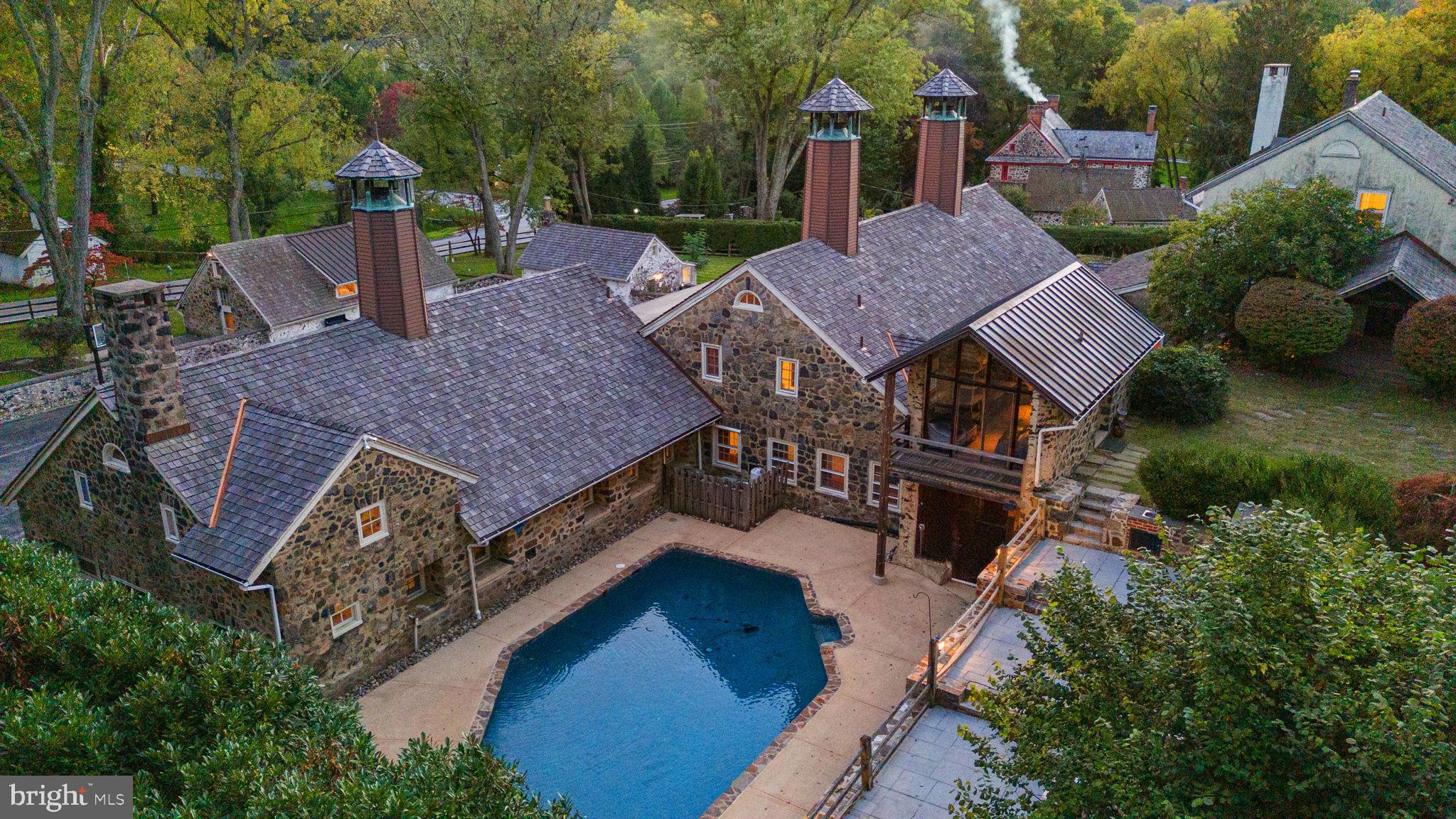 Discover a historic gem in the coveted Radnor Hunt neighborhood.  A family compound property, formerly Echo Valley Farm which is part of the prestigious William Lewis Farmstead. This unique property has graced the Episcopal Academy House Tour, showcasing the best of the Main Line. This enchanting property sits on 1.83 picturesque acres.

Housed in the original Granary, the gated entrance to the main residence features a sun drenched garden patio, gourmet kitchen with secondary butler’s kitchen, luxury stainless appliances, refinished soapstone counters, fresh paint and original hardwood floors, leading to a captivating living room with exposed beams. The first floor master suite features vaulted ceilings and a marble bathroom with a jacuzzi tub. The second and third levels are a blank slate for the new owner to customize their perfect floorplan with a natural stone wood burning fireplace, large windows, a full bathroom and space for 2-3 bedrooms. 

The renovated barn has been converted into a majestic English style pub and gaming area. Above the barn there is a huge storage space with full bathroom, potential to renovate this space to create an artist-style loft.

Walk across the wood bridge to the secluded, refinished resort style pool with built-in kitchen and outdoor shower. The pool deck sits on an elevated flagstone patio wrapped by gorgeous natural stone walls - perfect for hosting events and family gatherings.

The property also includes a large office space adjacent to the barn with  guest house or in-law suite above. 
 The guest house offers a versatile living space with a full kitchenette, living room and bedroom.  There are also two lovely updated one bedroom guest cottages. Additional features include new HVAC, newer roof, natural gas for cooking and heating and public sewer. The total square footage of all dwellings is between 11,000 - 14,000 sqft.

The property seamlessly combines old-world charm with modern amenities just minutes from Episcopal Academy, White Manor country club and Downtown Wayne. Experience the essence of horse country along the prestigious Main Line. Your luxury lifestyle awaits – schedule your private viewing today!