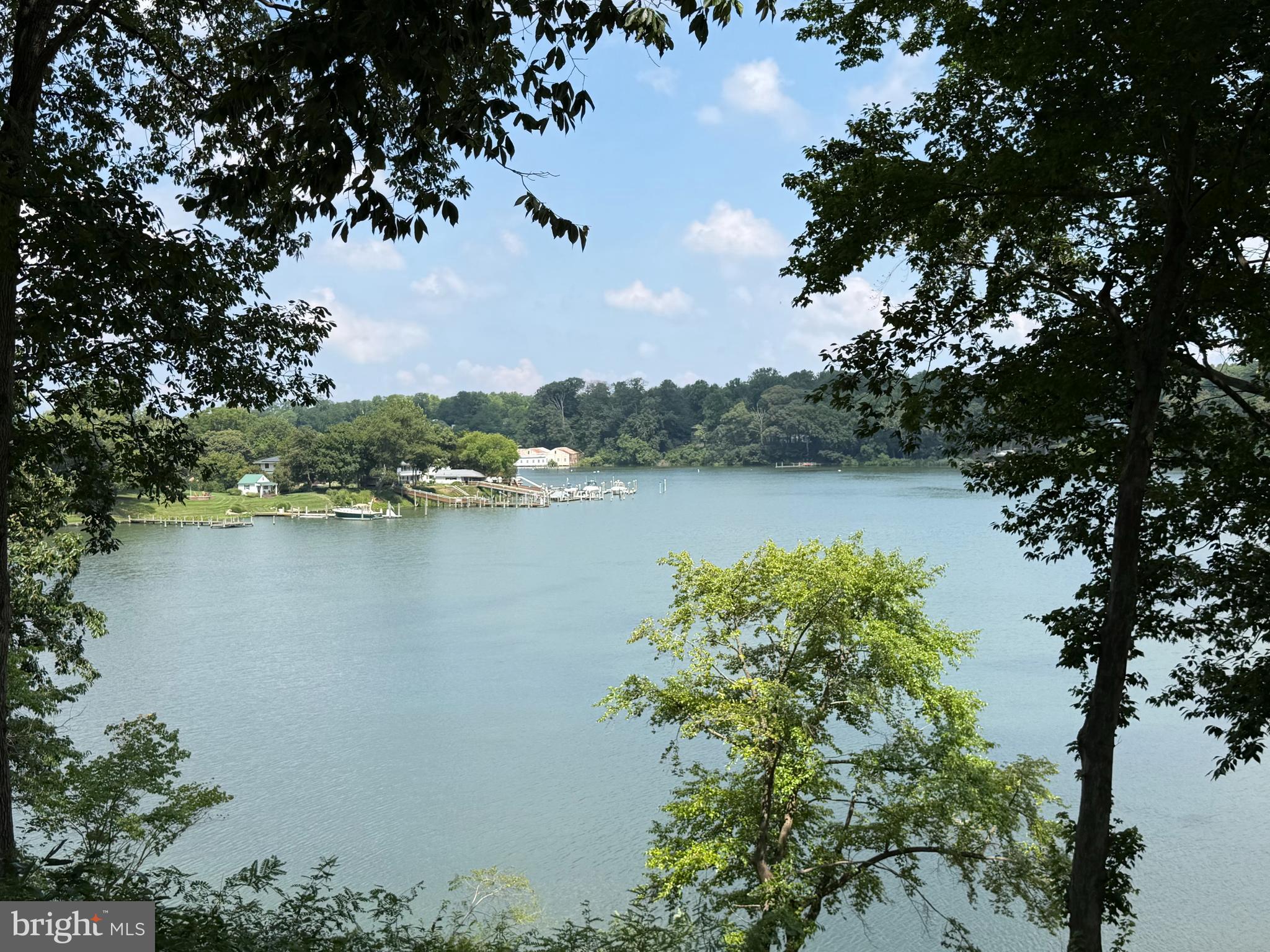 Enjoy sweeping water views, a bulkheaded shoreline, and a  lawn extending to the water's edge—an exceptional and hard-to-find combination. Boating enthusiasts will appreciate the private dock, complete with a boat lift and Jet Ski lift and the location on the river.

This charming four-bedroom home blends timeless character with everyday functionality. The thoughtfully designed floor plan features a first-floor primary suite, hardwood floors throughout, and spacious living areas ideal for both relaxing and entertaining. The detached garage includes a private apartment with an additional bedroom and an additional full bathroom, offering excellent space for guests or extended family.  Including the garage apartment, this property has 5 bedrooms and 3 full baths, 

The expansive kitchen and living area open through sliding glass doors to a  patio, screened porch, and beautifully landscaped lawn all overlooking the water, creating seamless indoor-outdoor living with broad water views. Mature trees provide shade, beauty, and privacy throughout the property.

Conveniently located just minutes from Georgetown, you'll enjoy easy access to restaurants and a sought-after boating destination. Whether your passion is waterskiing, wakeboarding, paddleboarding, fishing, or peaceful kayaking, this location offers endless opportunities to enjoy life on the water.

This is a property that truly should be experienced in person to appreciate its unique setting, exceptional amenities, and waterfront lifestyle.