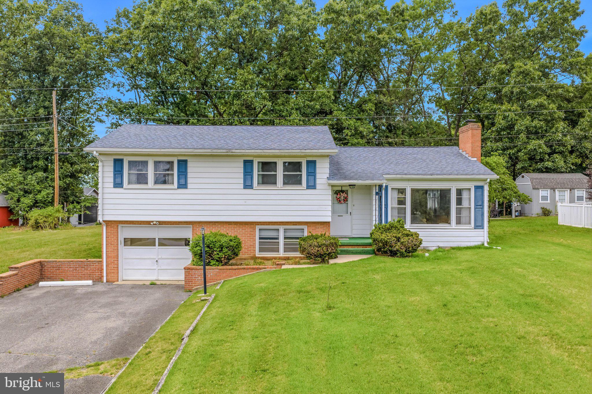 Very nice home located in a great location close to town, but far enough out to be peaceful.  Some beautiful hardwood floors, a wood burning fireplace, and laundry on the first level are great features. Other features are an attached garage, and finished lower level space. Very nice yard space with storage sheds also. Plenty of storage in the home and all paved roads and driveway. Lots of natural light and hand-made wood kitchen cabinets. A must see!