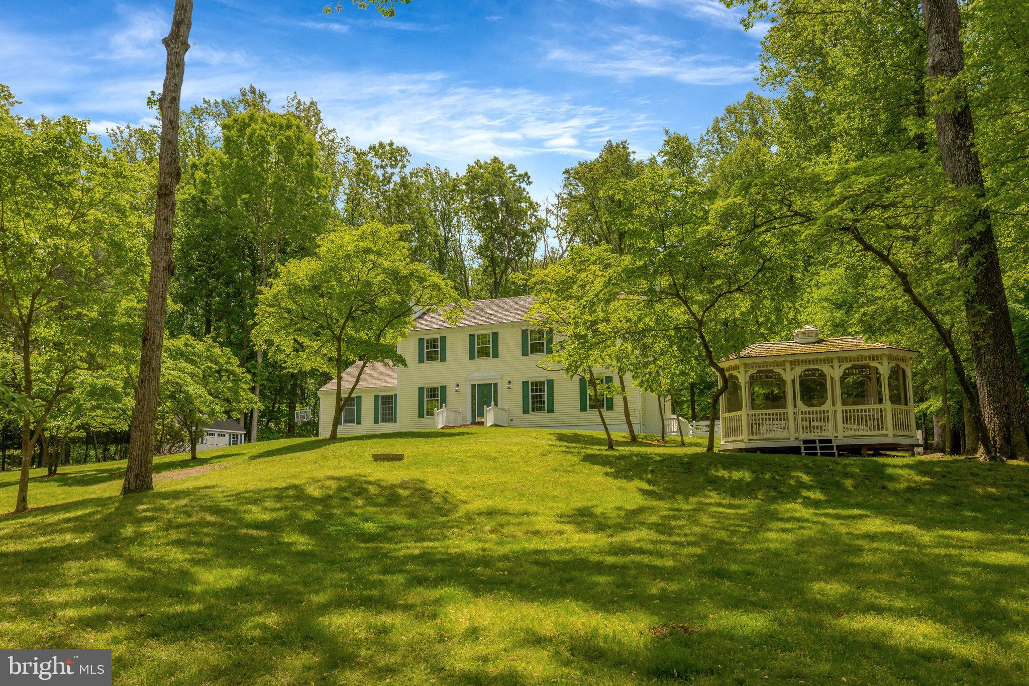 Unwind!  Enjoy Benefits of Being Outdoors!  Inviting Peaceful Cul-De-Sac Setting  Awaits Your Move to this thoughtfully updated home perfectly sited on 2.38 Acres of treed land in the desirable Potomac Forest neighborhood off sought-after River Bend Road location in the heart of Great Falls.  The entire wooded acreage has had attentive tree care creating an exceptional lot for play, entertainment and relaxation with tranquil private views from every corner of the property.   Several dogwood trees in the front yard have been cultivated to provide a burst of Springtime white blossoms.  The turnkey home with 3645 finished sq ft has been updated in 2024 – 2025 highlighted by interior painting on three levels, tastefully updated bathrooms, powder room and kitchen, new light fixtures plus recessed lighting, Two HVAC systems, Water Heater and new carpet in upper level rooms.  You will appreciate splendid wood floors on both the main and lower levels.  The main level living and sitting rooms have wood burning fireplaces.  The light-filled eat-in kitchen has new appliances with a gas cooking and attractive Corian countertops.  The kitchen area has a huge walk-in pantry and access from eat-in section of the kitchen to the deck overlooking the partially fenced yard with acreage extending far beyond the fence.   A powder room and dining room with Dutch doors complete the main level.  The upper level features the primary suite with a spacious walk-in closet, private bath with double sink vanity and a sitting room.  A fourth bedroom on the upper level was converted to the primary sitting room or nursery and offers additional closets.  There are two other bedrooms, two large hall closets plus a very convenient laundry area on the upper level.  The large hall bath on the upper level has a bath + shower plus an extra walk-in shower.  The expansive walk-up lower level has much to offer: a fourth bedroom, office, exercise room, large open recreation room plus a second convenient laundry area with New Washer and Dryer.  A premium perk is the over-sized Three Car Heated Garage!  Two custom made garden sheds have interior upgrades and the custom made screened gazebo with seating are color coordinated with the main residence to enhance the extraordinary land.  A bonus backyard, second driveway offers ample additional parking for dozen or more cars ideal for gatherings.  9201 Potomac Woods Lane is a very special home four minutes and equidistant to Great Falls Elementary School, River Bend Park, Great Falls Village Center featuring shops and restaurants and the Great Falls Post Office.  Tysons Corner & Reston Town Center attractions plus nature’s wonders at Great Falls National Park are just short distances away.  Potomac Woods is in the coveted Langley High School Pyramid.