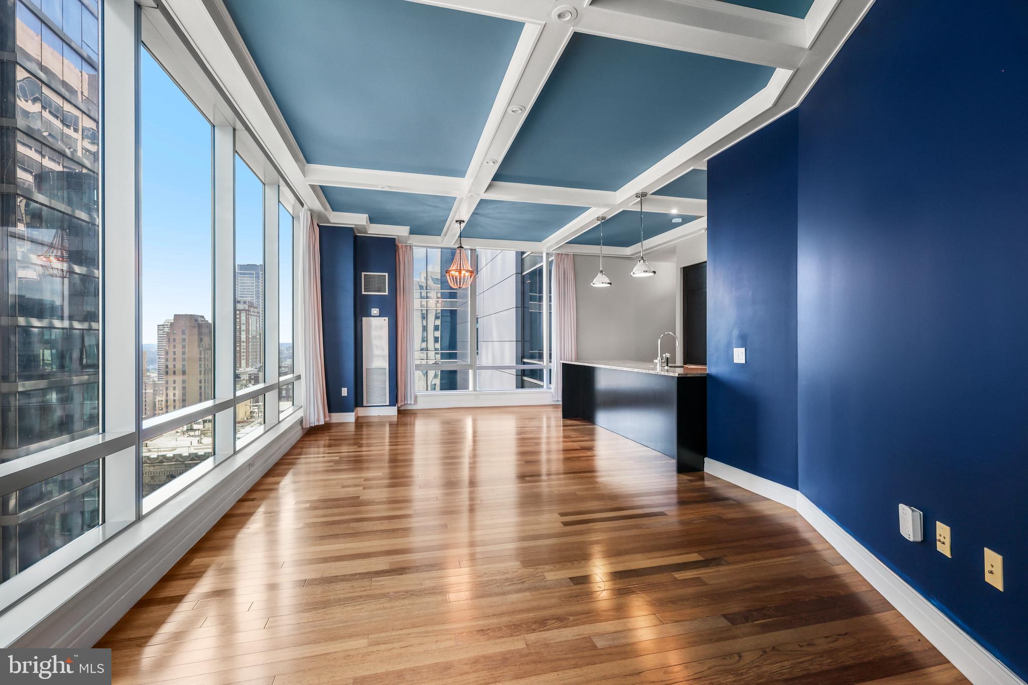 Experience unparalleled urban sophistication in this pristinely maintained high-floor sanctuary at The Ritz-Carlton Residences. Bathed in natural light from triple exposures—East, South, and West—this elegant 2-bedroom, 2-bathroom home offers sweeping, panoramic views of the vibrant Philadelphia cityscape from every room.
The seamless open floor plan is designed for both grand entertaining and quiet nights at home. At the heart of the residence, the gourmet kitchen boasts a large natural stone eat-at peninsula, a Viking gas range, Sub-Zero refrigeration, and a Miele dishwasher, all accented by a stylish glass tile backsplash. Retreat to the primary suite to find ample closet space and a spa-like quartz ensuite complete with a soaking tub and glass-enclosed shower. The secondary bedroom is equally generous, situated across the entry vestibule for maximum privacy. Modern comforts abound, from brand-new plush carpeting in the bedrooms to remote-controlled automatic blinds on every window for effortless light control.
Living at The Ritz-Carlton provides a lifestyle of effortless luxury. Residents enjoy a 24-hour concierge, valet parking, and private chauffeur service, along with a state-of-the-art fitness center featuring a 60-foot lap pool, hot tub, and yoga room. Socialize in the resident lounge—available for private events at no additional fee—or enjoy the media room, newly renovated outdoor terrace, and a gated garden leading directly to the hotel. This pet-friendly building even features an on-site dog park for your four-legged companions. For the ultimate city convenience, underground garage parking is available for purchase at an additional cost.
Perfectly situated at the literal pulse of Center City, you are steps from Dilworth Plaza, the Avenue of the Arts, and the city’s premier dining and retail. Make Philadelphia’s most prestigious address your own today.