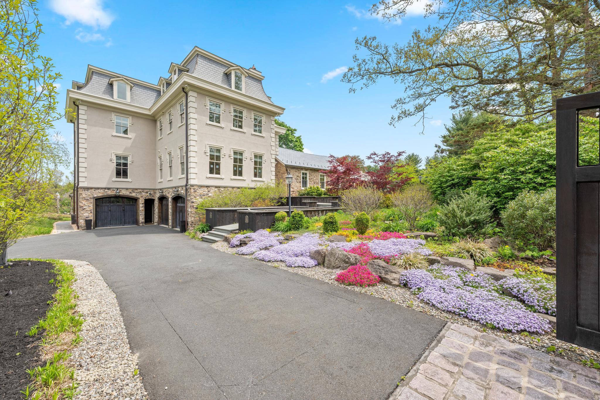 A renowned local architect melded a home reminiscent of the elegant late 19th Century manors of New Hope and Doylestown with a one room Pennsylvania stone schoolhouse dating back to the Civil War. This combination of rustic Bucks County charm with turn of the century bustling in- borough refinement creates a magical backdrop the new owner's next big adventure. The schoolhouse serves as the master suite, comprising a large bathroom, walk in closets, a changing area with built in cabinets and an expansive loft area that can serve as an office or exercise room. The master bedroom also has an adjacent windowed flower room with a pellet stove. The schoolhouse connects to the front entrance of the manor portion of the home. A stair down from the entrance takes you to a large playroom currently being used as a gym, three garages, another play area, a sitting area with a bar and a media room with a gas burning fireplace. The playroom and the media room have doors that open to a patio in the backyard. If you take two steps up from the entrance it leads you to a large kitchen replete with storage and counter space and numerous windows that allow uninterrupted views of the backyard and the neighboring 5 acre farm. The kitchen has a door that leads to a grand slate patio. From the kitchen you can enter the generous family living area with a gas fireplace, or you can choose to walk to the dining room that easily accommodates a table for twelve and has another gas burning fireplace. The third floor of this part of the home has three bedrooms and two full baths and the fourth floor has a bedroom, a full bath and a large sitting room and an office / study room. The entire floor could be converted into an in-law or au pair suite (If four floors seems daunting, there is an elegant elevator providing access to each floor. The house has so many beautiful features from hardwood floors and crown molding throughout to high end appliances and amazing views out the back windows. The home sits on a road that has a nature preserve and ends at Hansel Park - used for outdoor activities like soccer, jogging, biking, dog walking and outdoor concerts during the summer. While surrounded by nature, the location is close to local schools and shopping.
Don't miss your opportunity to see this unique home. Call for a showing today.