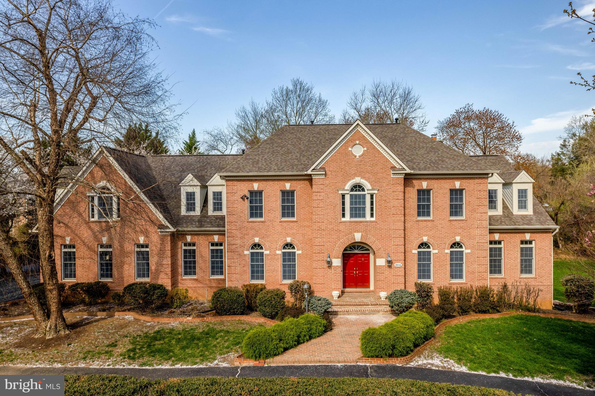 Welcome to this inviting brick home nestled in the charming Colvin Run Mill neighborhood.  A semi-circular driveway welcomes you to the 7,000 square ft residence offering 7 bedrooms, 5 full bathrooms and 2 powder rooms sited on 0.95 acres. With a formal entrance, revealing an impressive two-story foyer with an elegant staircase, perfect for hosting gatherings in the formal dining, living room and sunroom spaces.  Flowing seamlessly, the floor plan connects these areas to the generous family room and kitchen.  Designed to be open and airy, the family room boasts hardwood flooring, and an impressive, stacked stone fireplace.  Adjoining this area is the breakfast area and gourmet kitchen, complete with a central island gas cooktop.  A convenient catering kitchen, equipped with a second dishwasher, cooktop, sink and full-size fridge, is just steps away.   Completing the main level are a private office and two powder rooms. 
Upstairs, the grand owner’s suite awaits, featuring a cozy sitting room with a fireplace, two spacious walk-in closets, and a luxurious bathroom with double vanity.  Additionally, there are four bedrooms, two with ensuite bathrooms and two sharing a buddy bathroom.
The walk-out lower level is dedicated to entertainment and relaxation, offering ample space indoors and outdoors for guests.  With an ensuite bedroom, and a recreation room leading to the expansive patio area through an atrium door, this level is ideal for leisurely pursuits.