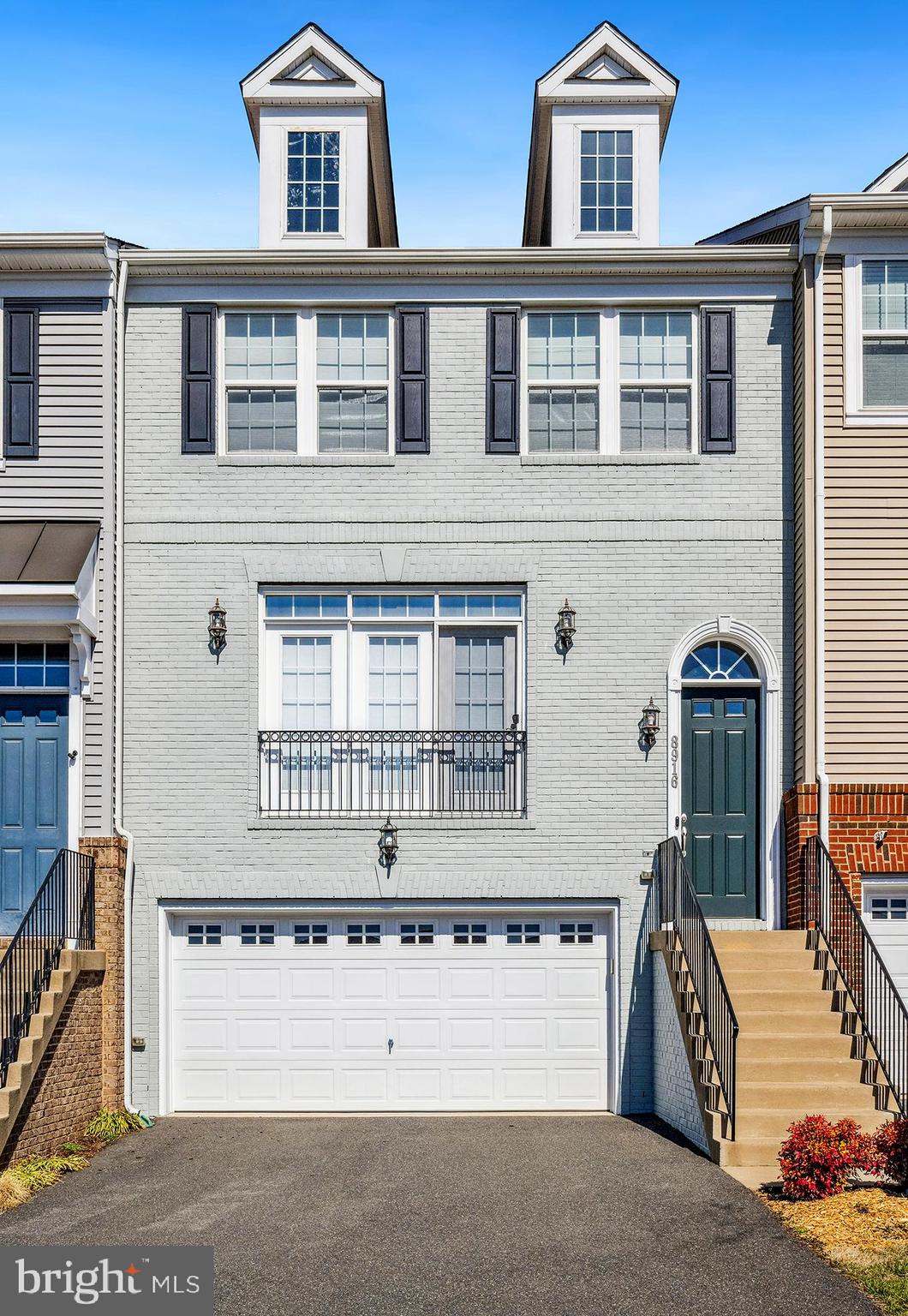 Welcome home to this stunning 3 Bedroom 3.5 Bath well maintained interior-unit townhouse in the desirable Bradley Square community.  This  2,354 sq. ft. Stanley Martin home was built in 2017 and offers everything you would want for convenience and comfort.   You will first notice when you enter this main level the beautiful wide plank hardwood flooring throughout.  This open-concept floorplan  offers easy access to living, dining and kitchen areas.  The beautiful gourmet kitchen offers a a spacious center island,  beautiful white cabinetry, granite counter tops, custom backsplash, stainless steel appliances with a double oven and built in microwave and a walk in pantry.  The recessed lighting and the large oversized windows and slider will give you all the natural light you could want.  The outdoor private deck will offer indoor-outdoor entertainment.   The upstairs offers 3 generous sized bedrooms with the primary having an attached bath with standup shower, separate toilet room,  second bath is located in the hallway. The laundry area is conveniently on this upper level.   The downstairs has the upgrade of hardwood flooring, walk out slider.  This could easily be an additional guest space as it offers a full bath.     The 2 car garage is oversized.   Plenty of guest parking and no homes directly in front of the property.  Plenty of guest parking.    This home is located in a prime location, close to VRE, all major routes, restaurants, shops, old town.   Lets make this your new home, move in, relax, enjoy!!