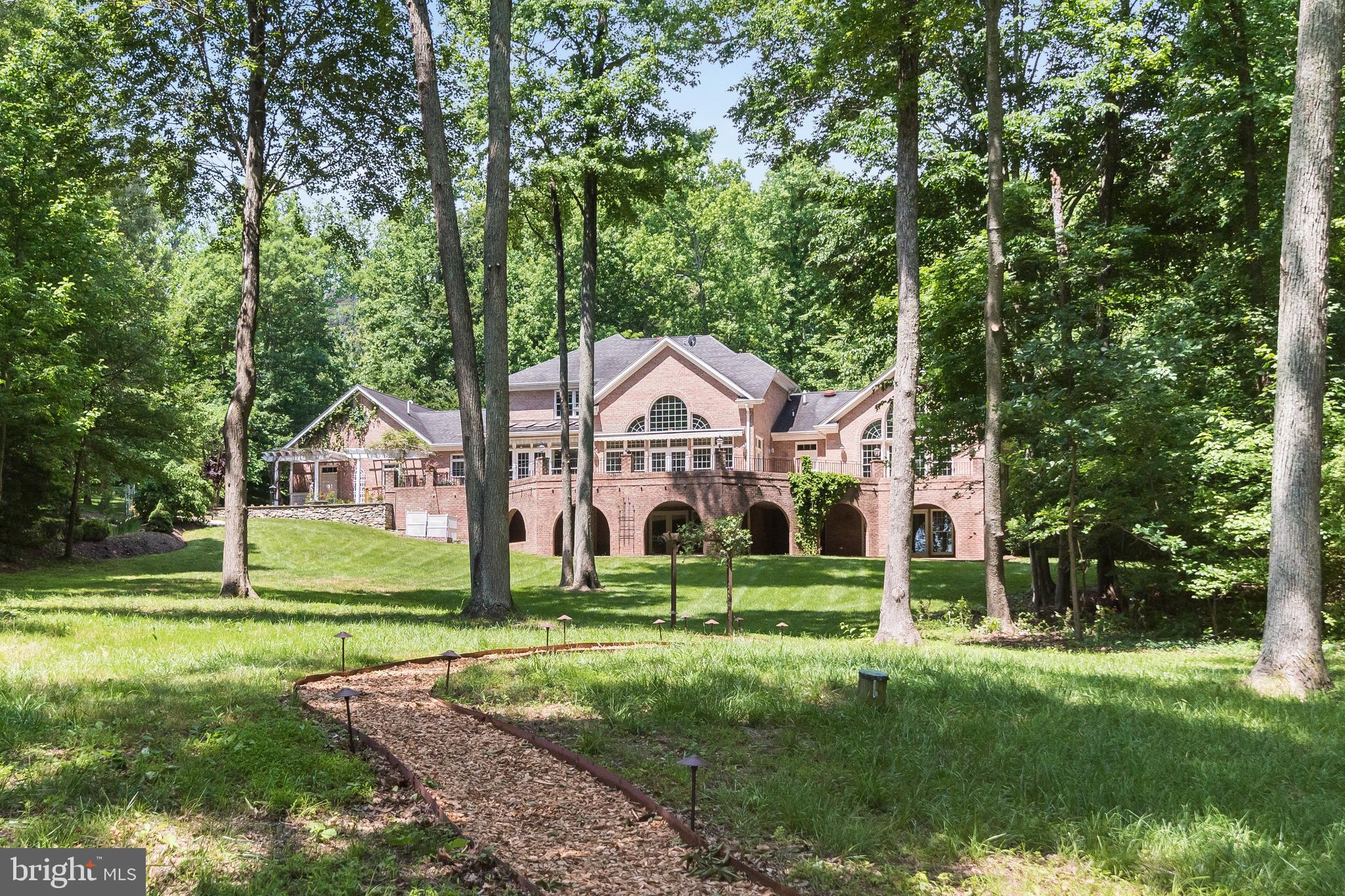 Enjoy peaceful, waterfront living on Old Point Peninsula, an exclusive enclave of 10 homes on 100 pristine wooded acres. Wake up to sunrise views over protected Larkington Cove, where your can keep your boat and be out on the South River in minutes. The home features soaring ceilings and walls of windows; a gracious, open floor plan ideal for entertaining; pristine wood floors with custom inlay; a floor-to-vaulted ceiling stone fireplace; and an expansive deck ideal for taking in views of the grounds, abundant wildlife, and protected cove. With over 8,000 square feet of living space, this home offers main-level living and includes 5 bedrooms, 5.5 baths, an in-law suite with a separate entrance and walk-out patio, and an attached 3-car garage.  A roomy main-level office also could be used as a nursery, den, or sixth bedroom. 

Recent 2024 capital improvements include a new roof and new HVAC systems. ​​​​​​Home also features a whole-house generator; underground watering system; 1000 gallon propane tank (owned); and pier with water, electric, 5000 lb. boat lift,  6' MLW depth. 

Additional photography and full, interactive floor plans will be posted February 28th, and home is available for showings starting February 28th.