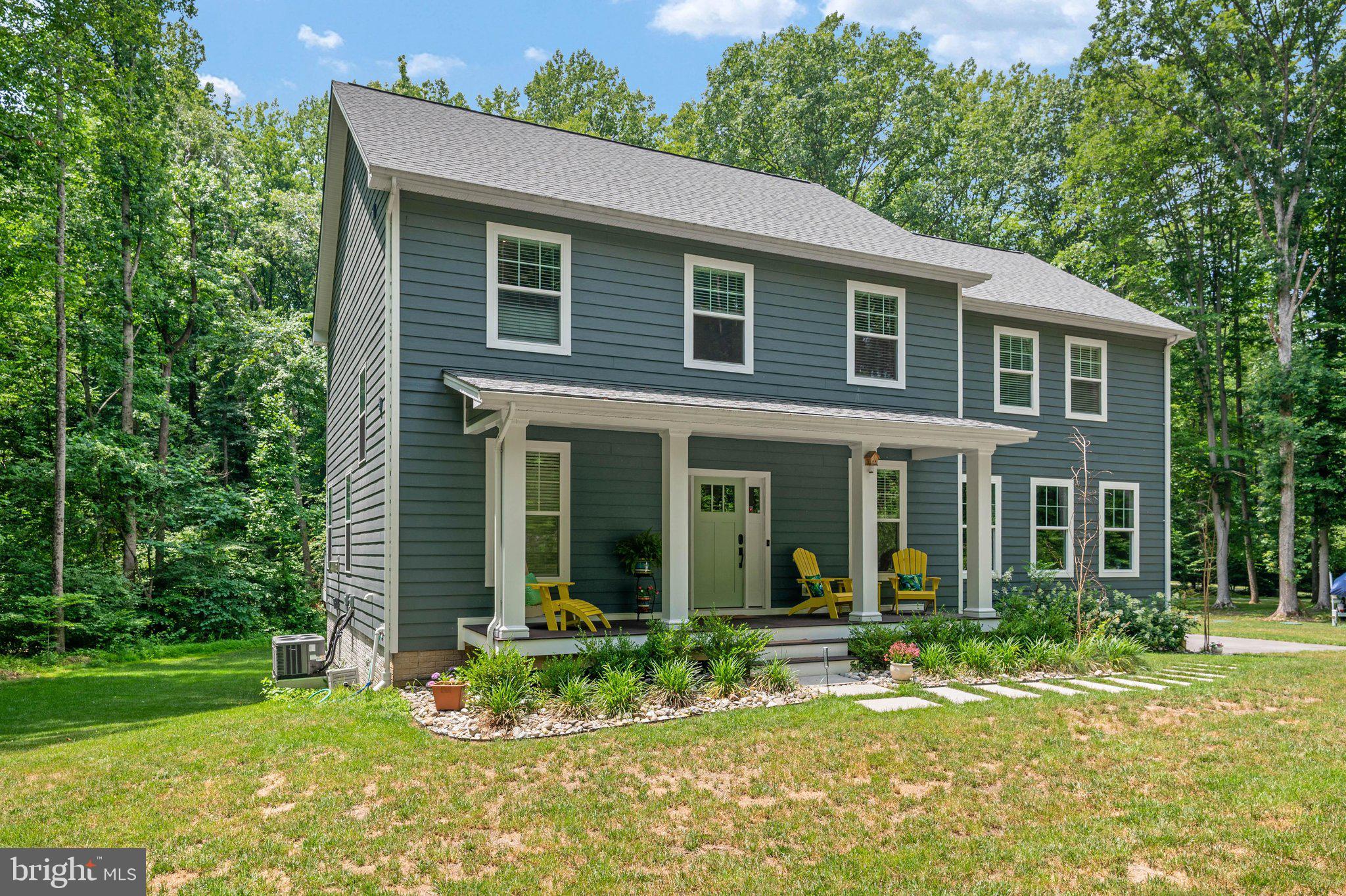 Welcome to this practically new custom home by Whitehall Building & Co., perfectly situated on 2.54 private, picturesque acres in the heart of Davidsonville. Offering the ideal blend of luxury, comfort, and convenience, this move-in-ready home showcases exceptional craftsmanship, high-end finishes, and thoughtful design throughout. Step inside to discover soaring 10-foot ceilings and an open-concept main level designed for both everyday living and effortless entertaining. The stunning gourmet kitchen is the heart of the home, featuring crisp white perimeter cabinetry, a striking oversized blue center island, quartz countertops, stainless steel appliances, and a spacious walk-in pantry. The kitchen flows seamlessly into the expansive family room with a cozy propane fireplace and walls of windows that fill the home with natural light, as well as the adjoining dining area, creating the perfect setting for gatherings of any size. A private home office and convenient powder room complete the main level. Just off the family room, a full-length Trex deck overlooks the private, tree-lined backyard, providing an exceptional outdoor living space for relaxing, dining, or entertaining. Upstairs, retreat to the luxurious primary suite featuring a spa-inspired bath with a double vanity, oversized walk-in shower, private water closet, and a generous walk-in closet. Three additional spacious bedrooms, a versatile loft, a well-appointed hall bath with double sinks and a tub/shower combination, and an upper-level laundry room complete the second floor. The fully finished lower level is an entertainer's dream. Enjoy movie nights or game days in the expansive recreation room featuring a full custom bar. This level also offers a fifth bedroom, a full bath with a luxurious steam shower, and a dedicated fitness room, providing flexible space for guests, hobbies, or multi-generational living. If you've been searching for privacy without sacrificing convenience, this exceptional property delivers. Nestled on over 2.5 serene acres, yet just minutes from Annapolis, Baltimore, Washington, D.C., and Northern Virginia, you'll enjoy peaceful country living with easy access to major commuter routes, premier shopping, dining, and everyday conveniences. This is a rare opportunity to own a nearly new luxury home without the wait for new construction.