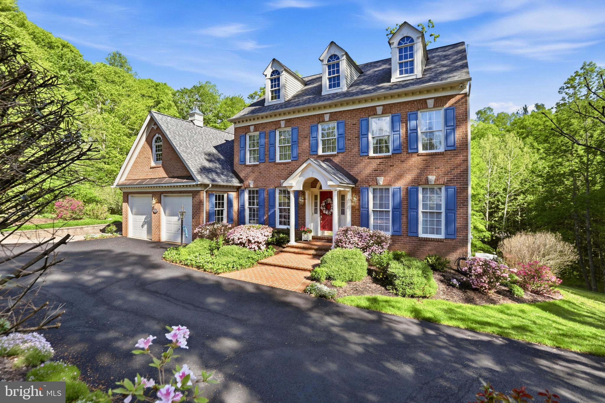 Looking for a meticulously maintained home on a private, picturesque lot at the end of a cul de sac? This one delivers. Set on over three acres with a mix of open space and mature woods, the property welcomes you via a newly paved circular driveway leading to a charming brick-front home.
The beautifully landscaped grounds feature extensive low-maintenance hardscaping, lush gardens, including an automatic in-ground sprinkler system, and a tranquil gazebo—perfect for relaxing and enjoying nature. Inside, the traditional center-hall colonial design offers a welcoming foyer, a spacious living room, and a private office with glass doors at the front of the home.
The light-filled kitchen showcases white on white cabinetry and countertops, an island with breakfast bar, and a sunny breakfast area that opens to a covered deck. Complete with two ceiling fans, the deck offers a quiet and private space overlooking the backyard. Just off the kitchen, the formal dining room features hardwood floors and a large bay window.
The inviting family room offers a wall of built-ins and a cozy wood-burning fireplace. Upstairs, the primary suite includes a luxurious en suite bath and two walk-in closets. Four additional bedrooms—one with its own en suite bath—and a hall bath complete the upper level.
The walk-out lower level provides a spacious recreation room, a full bath, a sixth bedroom, and two storage areas with shelving that convey.  The lower level steps out to a beautiful stone patio that wraps around the house.
A truly beautiful home you won’t want to miss.  No HOA!