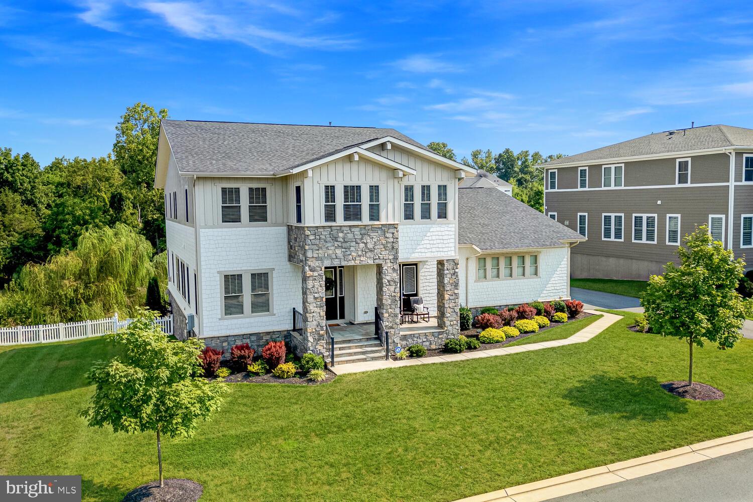 Experience unparalleled luxury with this breathtaking estate home, ideally situated on a premium lot in Ashburn's most exclusive neighborhood. The extraordinary Timberneck model stands as a true masterpiece of design and craftsmanship, showcasing an array of high-end upgrades and bespoke features.
<br><br>
The home instantly enchants with its undeniable curb appeal. A charming covered front porch, surrounded by manicured landscaping, creates a warm and inviting first impression. The interior of this home is a showcase of impeccable finishes. Wide-plank hardwood floors, high-end fixtures, oversized windows, and soaring 10-foot ceilings create an ambiance of luxury and sophistication. The spacious three-car garage seamlessly blends practicality with style, offering ample space for vehicles and storage.
<br><br>
The stunning gourmet kitchen is a true culinary masterpiece. Top-of-the-line appliances & cabinetry seamlessly pairs with elegant glass-front displays, while designer lighting and intricate moldings add a touch of refined charm. This kitchen is a chef's paradise, elevated by custom built-ins, including a massive center island and a generously sized walk-in pantry. The adjacent breakfast room and the expansive family room, featuring a cozy gas fireplace, create an inviting space that perfectly balances comfort and style. For more formal occasions, the elegant dining and living rooms offer spaces that cater to every entertaining need.  Work from home in the private study, which can also function as a main-level bedroom if desired, featuring a direct entrance to the front porch and conveniently located near a private full bathroom.
<br><br>
Upstairs, you’ll be captivated by the continuation of luxurious details that define this home. The primary suite serves as a serene retreat, complete with a sitting area offering picturesque views of the tree line.  The opulent primary bathroom is a haven of indulgence, offering a  walk-in shower, a deep soaking tub, and an expansive walk-in closet. Every element of this suite has been thoughtfully designed to represent the pinnacle of comfort and elegance.
<br><br>
Additionally, the upper level boasts four generous bedrooms, with two featuring their own private en-suite bathrooms, providing an added layer of convenience and privacy. The other two bedrooms are connected by a well-appointed Jack and Jill bathroom, offering both comfort and practicality.
<br><br>
The fully finished walk out basement boasts a generously sized recreation room with a gas fireplace and a wet bar. There is ample space to include a media room, home gym, gaming room, or any other purpose you envision for this versatile area. Ample storage space ensures everything has its place, while two additional bedrooms and a full bathroom provide flexibility for guests or extended family. The soaring 10-foot ceilings throughout the lower level further enhance the sense of grandeur.
<br><br>
The outdoor spaces are thoughtfully crafted to provide an effortless and enjoyable entertaining experience. The Trex deck seamlessly connects to the paver patio below, creating an inviting atmosphere ideal for both relaxation and social gatherings. Whether hosting an intimate dinner under the stars or a lively outdoor celebration, these spaces offer the perfect backdrop for every occasion.
<br><br>
Ideally situated in the heart of Willowsford, this home offers unparalleled access to everything Northern Virginia's premier neighborhood has to offer. With proximity to top-rated Loudoun County Schools, major commuter routes, upscale shopping, and thriving businesses, this property represents a rare opportunity to own a truly exceptional estate in a coveted location. The Timberneck model is more than just a residence; it embodies a lifestyle of luxury, comfort, and ultimate convenience. Seize the opportunity to make this remarkable estate your own and experience the best of what Willowsford has to offer!