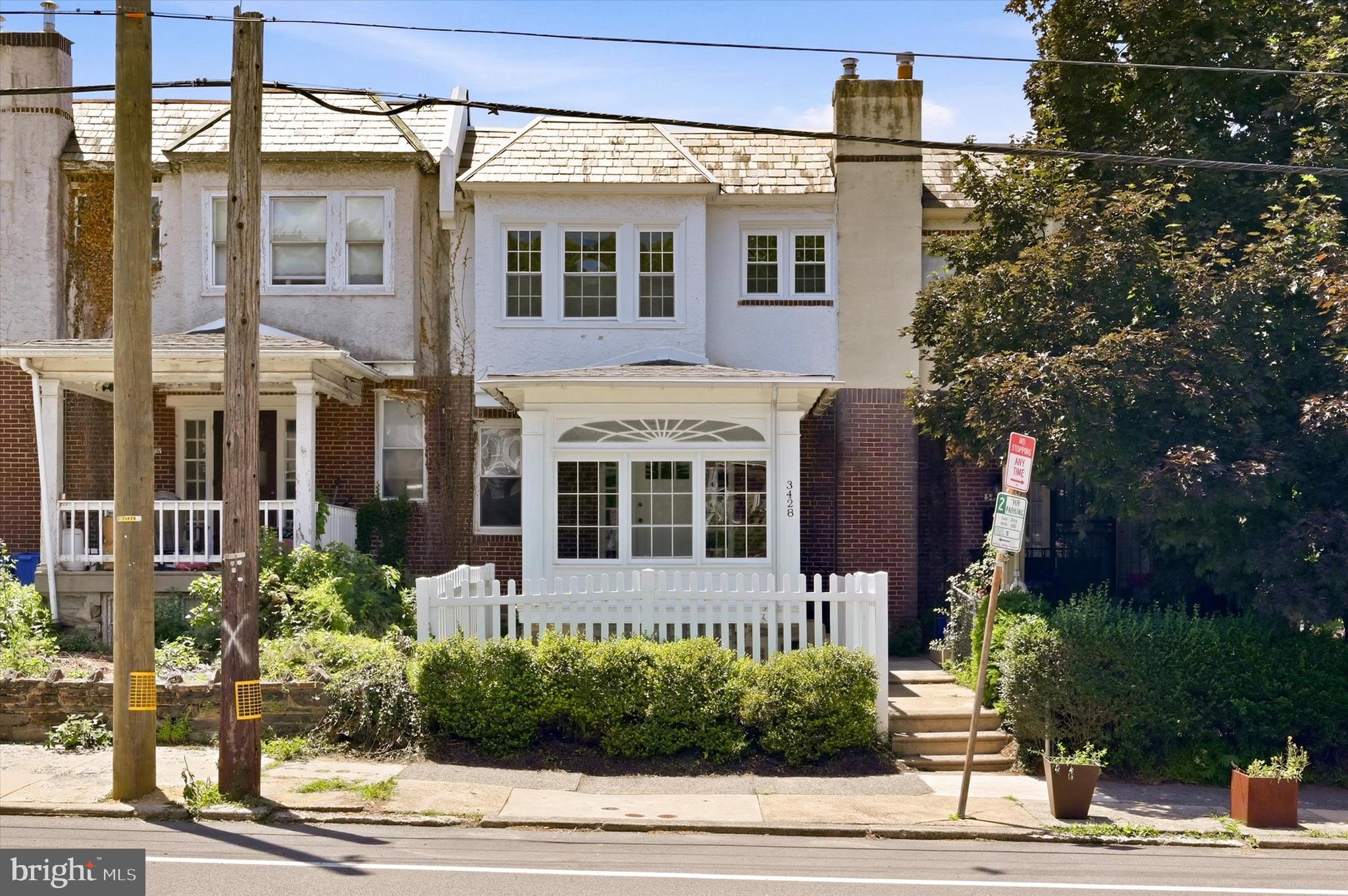 Welcome to 3428 Vaux Street, nestled on one of the most desirable blocks in Philadelphia’s highly sought-after East Falls neighborhood. This beautifully maintained home seamlessly blends the timeless craftsmanship of its original design with the modern updates today’s buyers are looking for. A charming glass-enclosed front porch welcomes you inside, where beautifully refinished original hardwood floors, abundant natural light, and an open-concept layout create an inviting first impression. The spacious living and dining areas flow effortlessly together, making the home ideal for both everyday living and entertaining. Just beyond the dining room, a large rear deck offers the perfect extension of your living space ideal for morning coffee, summer barbecues, or relaxing evenings with family and friends. The thoughtfully designed kitchen features new appliances, ample cabinetry, and an open layout that keeps you connected to the heart of the home, whether you’re preparing a quiet weeknight dinner or hosting holiday gatherings. Upstairs, the spacious primary bedroom is filled with natural light and offers generous closet space. Two additional bedrooms and a well-appointed hall bathroom complete the second floor, providing flexibility for family, guests, or a home office. The walk-out lower level offers exceptional storage and direct access to valuable off-street parking—an amenity that is increasingly hard to find in the city. This home has been lovingly cared for and thoughtfully updated, giving buyers peace of mind for years to come. Recent improvements include an upgraded heating system (approximately three years old), replacement windows, a hot water heater installed in 2025, fresh neutral paint throughout, and a meticulously maintained roof with protective coatings applied every two years. Living in East Falls means enjoying one of Philadelphia’s most desirable neighborhoods, known for its tree-lined streets, strong sense of community, neighborhood cafés and restaurants, local shops, nearby parks, and easy access to Center City, major highways, public transportation, and the scenic Schuylkill River Trail. Offering classic charm, meaningful updates, and an unbeatable location, 3428 Vaux Street is truly move-in ready and presents an exceptional opportunity to own a home in one of Philadelphia’s most cherished neighborhoods.