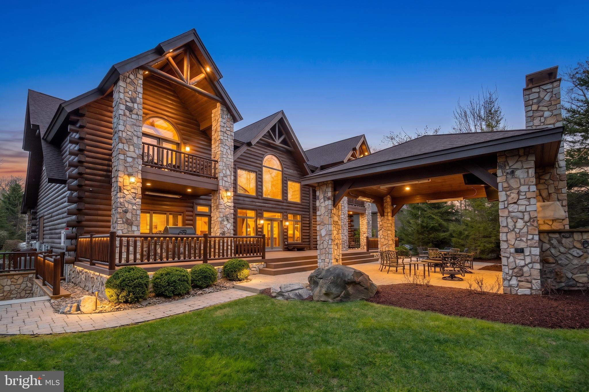 Experience the pinnacle of mountain luxury in this extraordinary custom log estate. Showcasing impeccable craftsmanship and refined rustic elegance, this one-of-a-kind retreat features a deluxe wine room, private sauna, billiard/game room, fitness area, large mudroom, and an indoor hot tub designed for year-round relaxation. Expansive windows from most rooms create a seamless connection to nature. The gourmet kitchen leaves nothing to the imagination, offering a six-burner gas range, large granite island, eat-in bar, cathedral ceilings, and access to the rear patio. The great room boasts a floor-to-ceiling stone fireplace and plenty of large windows that allow you to enjoy the beauty outside during any season. With six en-suite bedrooms and laundry on each level, your guests will be more than comfortable. The media/theatre room with an impressive wet bar is another bonus, and a great place to relax and have family time after a long day on the slopes. Picture hosting unforgettable cookouts with friends and family on the expansive rear brick patio, thoughtfully designed with a built-in grilling area, cozy fireplace, and a comfortable seating and TV area—perfect for relaxing or entertaining in style. With a 3-car attached garage and an epoxy floor, there is ample storage for vehicles and recreational toys. An additional lot provides enhanced privacy, making this an exceptional investment in mountain living. Conveniently located in the North Camp community atop Wisp Resort, premier skiing is just around the corner. There are also two golf courses close by, as well as all the recreation that Deep Creek Lake provides. Adventure and tranquility can both be yours from this remarkable haven!