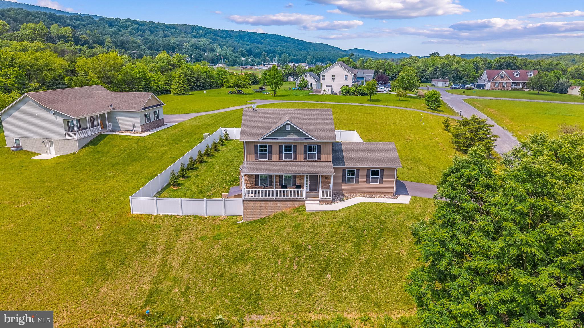Escape the City: Luxury Mountain Retreat in Berkeley Springs. Discover ultimate peace and tranquility in this beautifully maintained, move-in-ready premium home, less than three years old. Nestled in a peaceful wooded setting with breathtaking mountain views, this estate offers the perfect sanctuary from the hustle and bustle of Washington DC and Baltimore, just a short drive away.

The Living Space: Designed for exceptional indoor and outdoor living, the main level features an inviting layout with a cozy fireplace and a modern custom kitchen. The fully finished walkout basement adds an entire level of luxury living, featuring a large recreation area, an extra bedroom, a full bath, and abundant custom storage.

Outdoor Oasis: Step outside onto the expansive upper deck or the lower-level patio, complete with a retractable awning and outdoor furnishings — perfect for relaxing, entertaining, or listening to the birds. The backyard features a premium privacy fence, making it an absolute paradise and a secure haven for your large pets.

The Location: Immerse yourself in nature. You are just minutes away from the pristine trails of Cacapon State Park and the historic, healing mineral springs of downtown Berkeley Springs.This is a true turnkey opportunity to own a piece of mountain paradise.