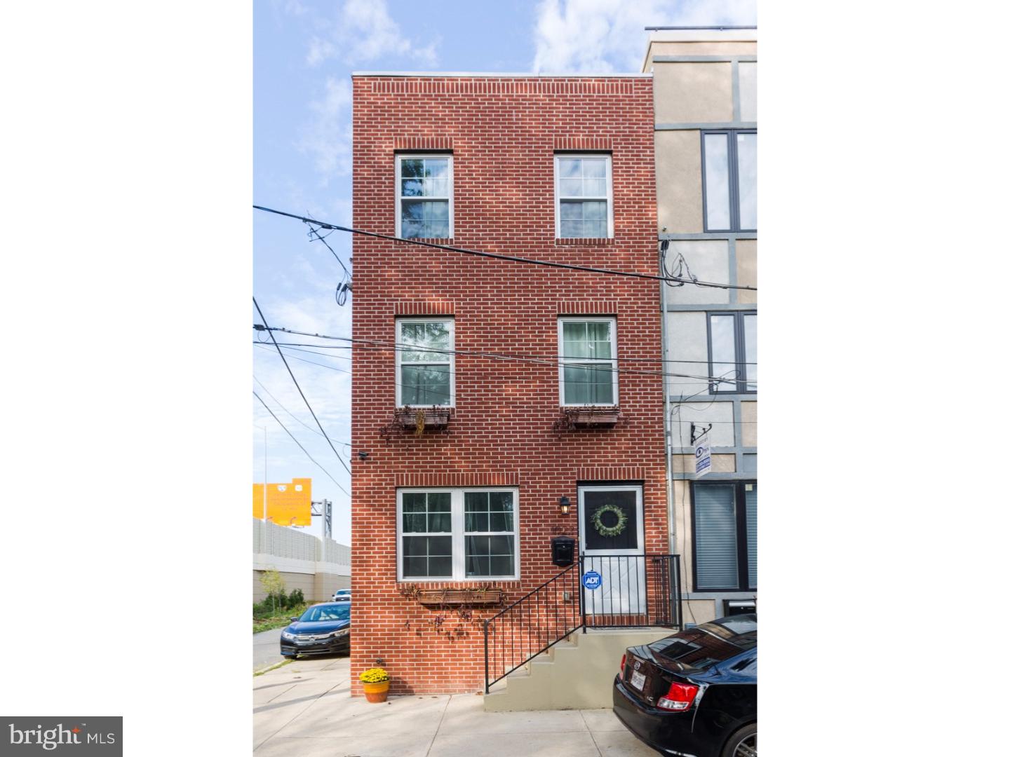Welcome to this 3 story, large corner, brick front, 3 bedroom, 2.5 bath with 2 decks! This awesome home has 3 years remaining on the tax abatement and is located on the highly desired and incredibly charming Riverside part of Fishtown. Parking is so easy and abundant on this street (its the best kept secret!) and in addition to street parking there is abundant public green space across the street that is maintenance free. We love that it is in walking distance to all of your favorite restaurants and social venues. Walk up off of street level and enter in to the open layout with hardwood floors, recessed lighting, and a convenient powder room. This floor is filled with natural light, has a peninsula kitchen with breakfast bar, beautiful polished Quarts counters, goose neck faucet with under mount stainless sink, top of the line stainless appliances, glass bread stick patterned subway back splash and modern Shaker style wood cabinetry. There is a door to the rear deck that is perfect for the grill to table experience year round! The huge unfinished basement is waiting to be finished with 500 sq feet of potential bonus space and with very high ceilings and a large light well for natural light. (We're thinking yoga studio, man cave, jam sessions with the band :) ... The upper levels are where the bedrooms are located. The 2nd floor has 2 nice size bedrooms with a shared hall bath and plenty of closets space The 3rd floor has a walk out deck, a full master bath, and large master bedroom. Other things we'd like to mention is: Gas line hook up in the living room for a romantic gas fire place, the home has almost 1,500 square feet of living space (not including the basement), central air, side by side washer and dryer included in basement, alarm security system, cool neighbors, and impeccably maintained throughout. We welcome your visit today!