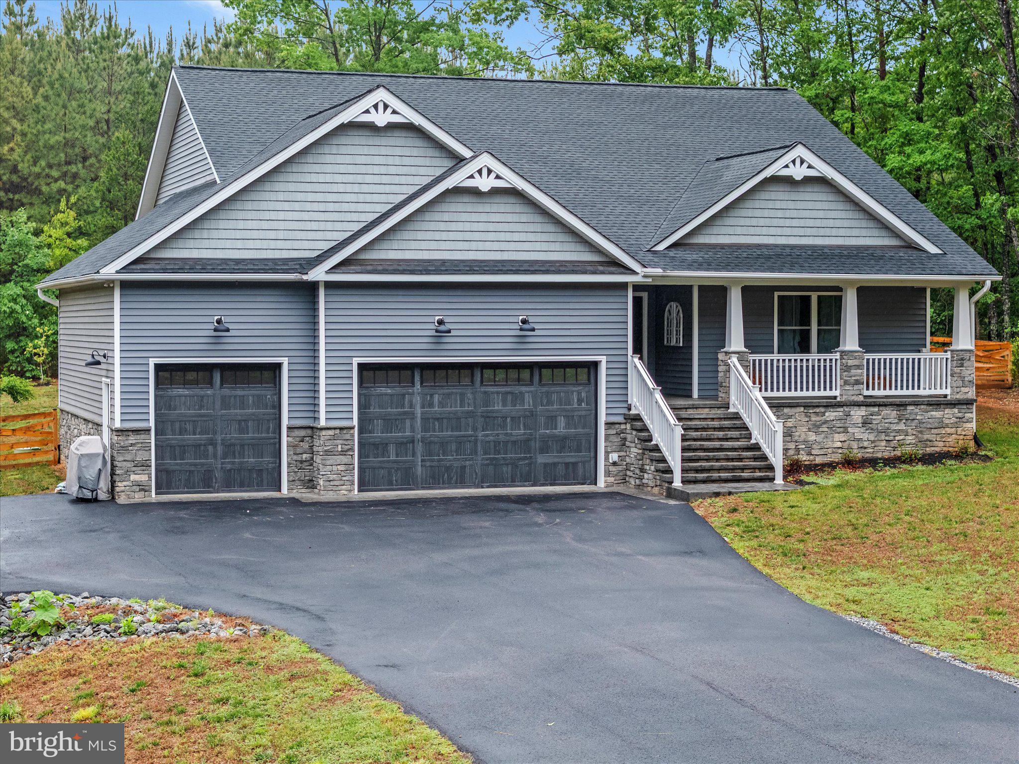 Custom-built in 2022 and better than new — this one-level craftsman in gated Shenandoah Crossing offers what nearby
new builds can't: a 3-car garage, whole-home generator with transfer switch, encapsulated conditioned crawlspace, central
vacuum, and a private half-acre backing to woods. Inside, a stone gas fireplace anchors the open great room under
cathedral ceilings, with hardwood and tile throughout, a granite kitchen with island and gas cooktop, and a primary suite
with double vanity and walk-in closet. Thoughtfully designed for single-level living at every age and stage, with accessible
entry via the garage lift, wide hallways and doorways, and a low-threshold shower. Pre-inspected with all repairs
completed — truly move-in ready. Outside your door: a 60-acre lake for kayaking and fishing, pools, fitness center,
pickleball and tennis, an equestrian center, and miles of trails. Xfinity high-speed internet makes remote work effortless.
Minutes to Gordonsville, an easy reach to Charlottesville, Richmond, and Zion Crossroads. Resort living, custom quality,
total peace of mind — schedule your showing today.