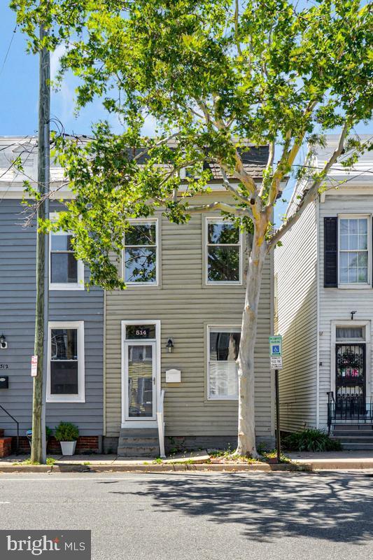 Rare opportunity in the heart of Old Town Alexandria — blocks from King Street, steps to Braddock Road Metro, and offering something few Old Town homes can: your own PRIVATE CARPORT for off-street parking. This light-filled 2-bedroom, 1-bath townhome blends historic character with recently refreshed finishes, including a newly painted pergola (June 2026) and a freshly repainted interior and deck (2025).

Original hardwood floors, extensive moldings, and built-in bookshelves set a timeless tone. The living room's classic architectural details flow into an updated kitchen with stainless appliances, gas cooking, generous cabinetry, and ample prep space. A large rear sunroom adds rare flexibility — perfect for dining, a home office, or additional living space — overlooking one of Old Town's largest private backyards.

Upstairs, the primary bedroom features dramatic vaulted ceilings, exposed-brick accents, and oversized windows, alongside a comfortable second bedroom. The full bath offers both a soaking tub and a separate glass-enclosed shower.

Outside is where this home truly stands apart: an exceptionally large, fully fenced backyard with an expansive deck, garden space with room for a shed, and a freshly painted pergola — plus the rare convenience of a private carport. With NO HOA fees and an unbeatable walkable location near restaurants, shopping, waterfront parks, and both King Street and Braddock Road Metro, this home delivers space and convenience rarely found together in historic Alexandria.