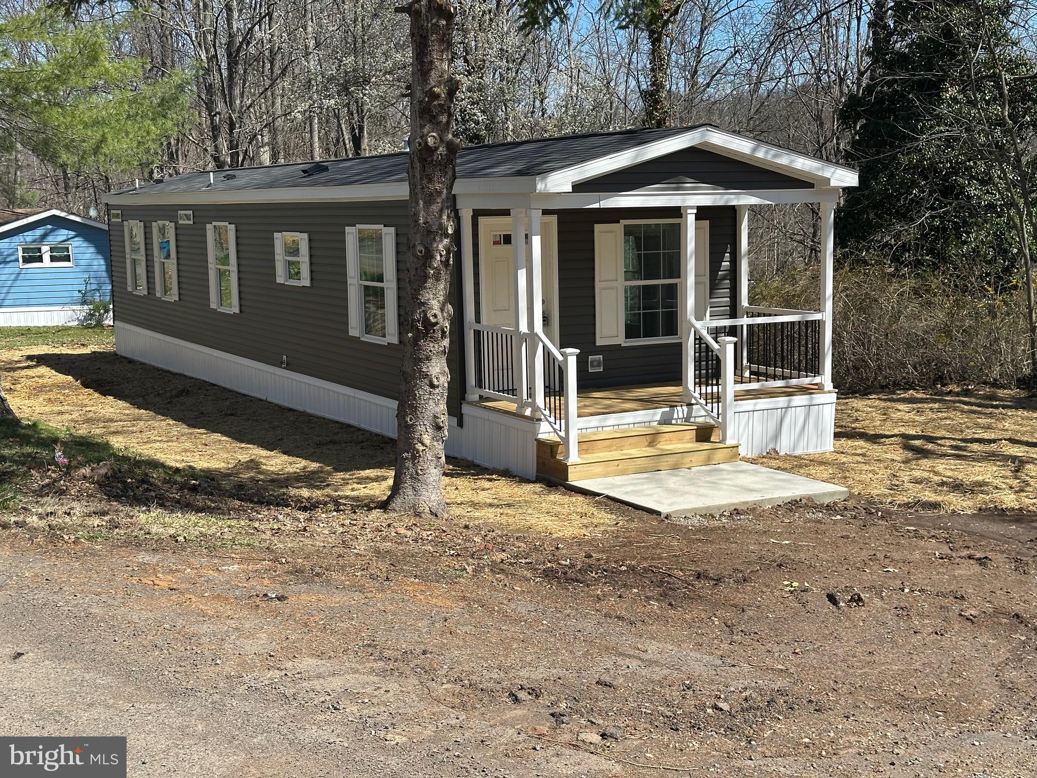 Enjoy watching nature from the porch of this cozy new  home nestled on a wooded lot. The open concept and vinyl floors provide low maintenance in the living areas and carpet allows for warmth in the bedrooms. Don't miss the opportunity to own this value priced home. Enjoy the park amenities included in the land lease of $991/mo . Park approval required