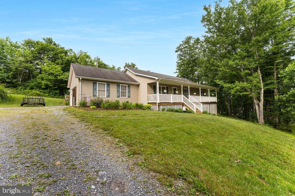 While heading out to wild and wonderful West Virginia make sure you stop by this Virginia rural retreat with little over 6 acres of woods, lawn, and a quick path to Rt.50 to head right into our great town of Winchester.  The ranch home is only 21 years young which the spacious and delightful open floor plan has the simple pleasures of roaming around without all the formal room blockades. Mix of hardwood and carpet and make sure you take in the front porch overlooking the neighbors pond and knowing you only have 3 neighbors.  The basement is a blank canvas with walkout access for storage needs or could be multiple future uses.  Unrestricted land use and there is a bonus of income from a billboard company.
