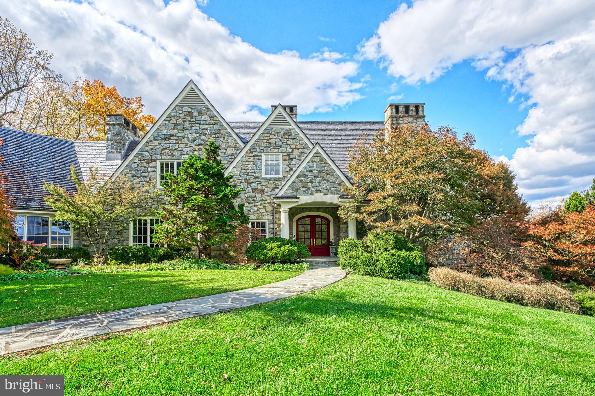 A living masterpiece, three decades in the making
Birchwood Estate is the rare convergence of visionary architecture, botanical significance, and unspoiled Virginia landscape. Designed by Loudoun County architect Kevin Ruedisueli and inspired by the celebrated English Arts and Crafts architect C.F.A. Voysey, the stone manor was completed in 1996 with hand-selected fieldstone, a slate roof, and meticulous attention to every detail of its construction. The residence offers approx. 9,000 finished sq. ft. across three levels, with a main-level primary suite, five additional bedrooms, a wine cellar, and multiple fireplaces — all warmed by geothermal systems and oriented to capture panoramic Blue Ridge Mountain views. Beyond the residence, the property encompasses approx. 37 acres of rolling meadow, mature forest, and one of the largest privately held arboretums on the East Coast — a world-class collection of rare conifers, Japanese maples, beeches, and specimen trees from across the globe. Catoctin Creek, a Virginia State Scenic River, traces the property's boundary, and the historic village of Waterford, a National Historic Landmark, lies just minutes away. Featured in Southern Home magazine, Birchwood has been thoughtfully restored and enriched by its current stewards, who revived the arboretum, added cutting and butterfly gardens, an apiary, and a fruit orchard. This is a property shaped by intention, sustained by care, and offered for the first time in seven years.