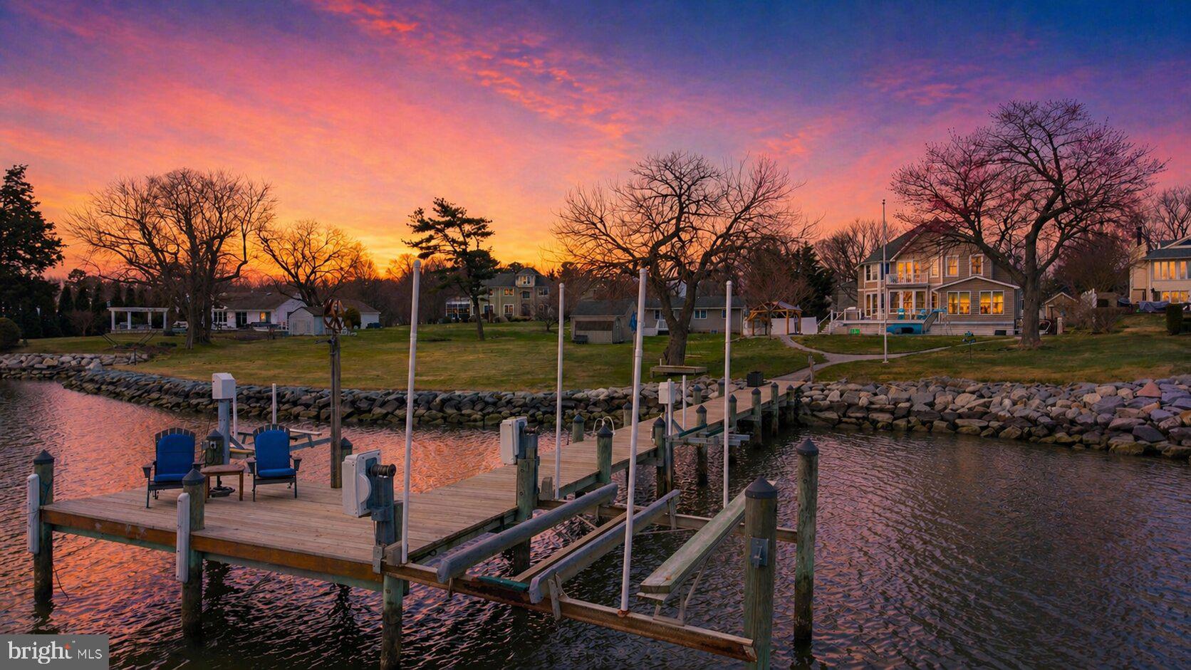 STUNNING waterfront private oasis just minutes from the Bay Bridge, where coastal luxury meets effortless Chesapeake Bay living. Nearly 3100 sf, , this gorgeous retreat features four spacious bedrooms and three beautifully updated baths, designed for comfort, style & unforgettable gatherings. Main level bedroom & full bath offer flexibility! The heart of the home? A magazine-worthy coastal kitchen with new custom cabinetry, gleaming white quartz countertops, & shiny stainless steel appliances. Wide-plank white oak flooring that carries warmth and sophistication. Open, airy, and filled with natural light — every space feels intentional and elevated. Primary suite emulates the  finest of hotels with cozy gas fireplace, catwalk to waterfront balcony, bonus room/office & STUNNING  spa bath with sunken tub, walk-in-shower & vanity for two, heated floors & spacious closet for ample storage. Step outside to your own resort setting — with private in-ground pool, expansive entertaining areas, maintenance-free deck with cable rails for nautical feel. and a private pier with boat lift & two jet ski lifts - just three lots from direct Chesapeake Bay access. With 4' MLW, boating enthusiasts will appreciate effortless access to open water in minutes. This is more than a home — it’s a lifestyle, waterfront living re-defined.  Opportunities like this don't float by twice- your boat belongs here!