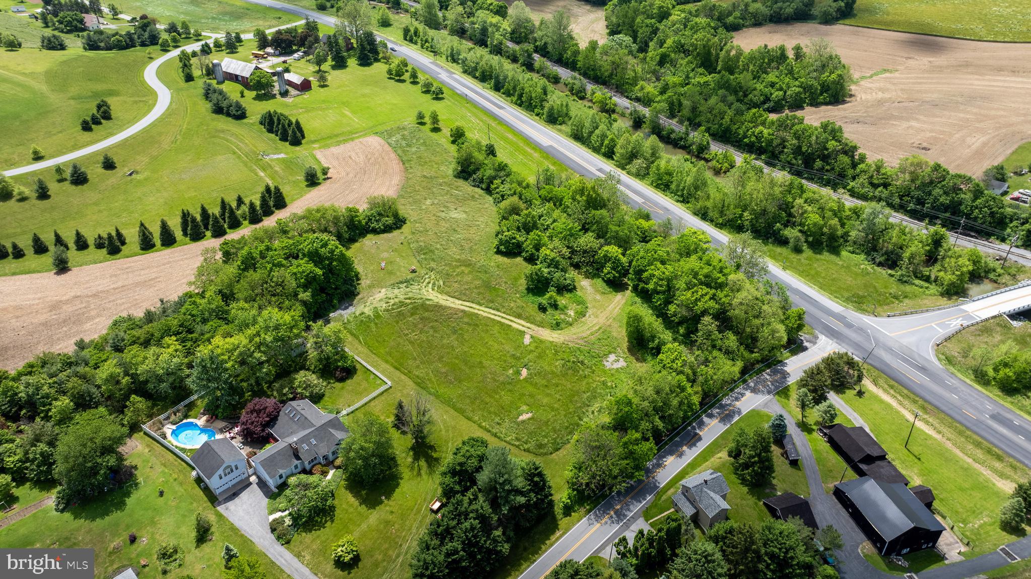 Location, location, location!  This is a TO BE BUILT HOME on a wonderful elevated flat lot with beautiful views of rolling hills and farmland and partly wooded for privacy.  A very very rare opportunity, as you know if you have been looking for land.  This lot has been perced and the well is drilled.   Working with a local Builder with over 35 years of experience makes the process easy and affordable. This spacious, open concept home has plenty of options for the home of your dreams.  Whether formal entertainment or a cozy farmhouse vibe, this is the house for you. . Choose the latest kitchen style and amenities with expansive island and walk-in pantry and various  options for a main level office/study and/or main level bedroom suite. Modern comforts such as a drop zone, covered front porch, 2 story foyer, propane fireplace, dual zone heating and A/C, and luxury vinyl plank floors are just a few of the enhanced living conveniences. Ascend the gleaming staircase to your upstairs retreat. Your substantial primary bedroom boasts a massive walk-in closet and a spacious custom bath, as well as an optional sitting room. There are 4 additional bedrooms, on the same level, a large hall bath with double vanity, and a bedroom level laundry to complete the retreat. There is an option for a main level bedroom and full bath as well. This home offers ample ability to add bedrooms, bathrooms, closets, etc. And if you still need room, there's over 1,500 sqft in the lower level that can be finished to your liking. Call today to start customizing this home to fit your needs! *Renderings/photos are to be used for marketing purposes only. The Builder does not guarantee that the home will be built with the exact same finishes shown. All specifications and customizations will be agreed upon in writing in the sales contract. See the attached spec sheet for all standard inclusions.* Blown yield rate with the drill was 20 gpm. The yield test produced 12 gpm which is the max for the pump so may be even more.