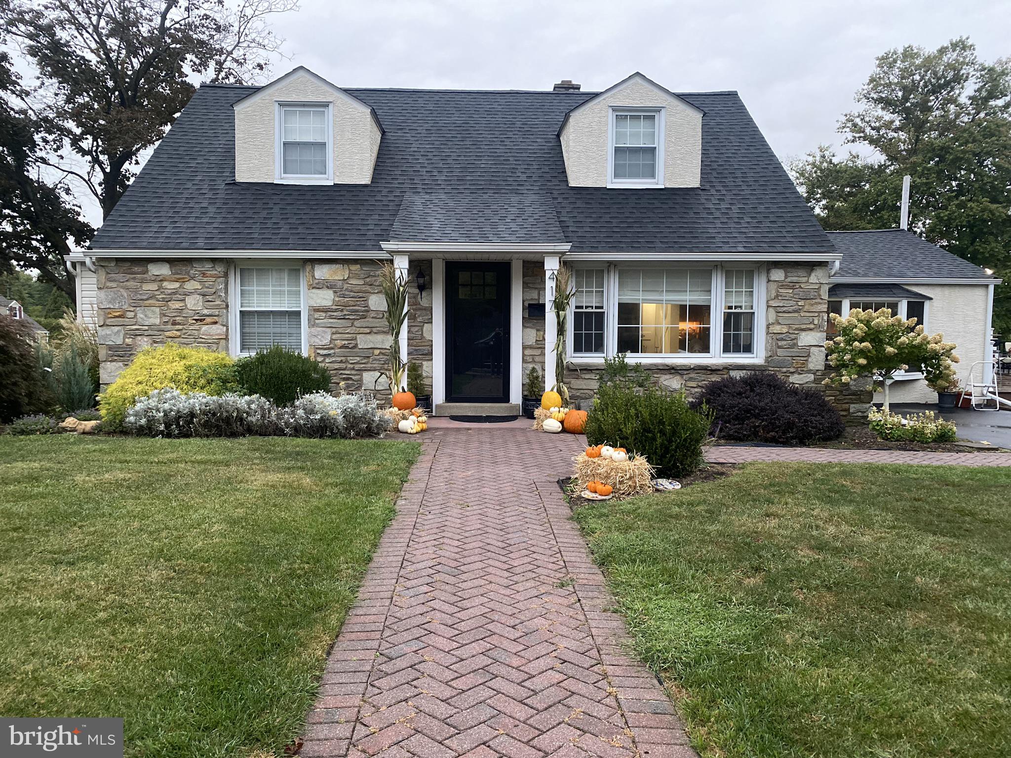 Welcome to this beautifully expanded Cape Cod, ideally situated in one of Flourtown's most desirable neighborhoods within the award-winning Springfield School District. Thoughtfully enhanced with three substantial additions, this impressive home offers over 2600 square feet of living space. Features include: an over-sized family room, 5 bedrooms, 2 full bathrooms, and 1 half bath—making it one of the largest homes in the neighborhood. Designed with both comfort and functionality in mind, the home features a spacious, open floor plan perfect for everyday living and entertaining. The stunning primary suite addition offers a generous bedroom, oversized closets, and a beautifully appointed en-suite bathroom, creating a true private retreat. At the heart of the home is the spectacular gourmet kitchen addition, showcasing a cathedral ceiling with exposed beams, stainless steel appliances, abundant cabinetry, and an effortless flow into the expansive TREX deck—ideal for outdoor dining, entertaining, or simply relaxing. The inviting family room addition features a cozy gas fireplace and includes a versatile fifth bedroom or bonus room, perfect for a home office, guest room, playroom, fitness area, or additional storage. Year-round comfort is ensured with energy-efficient mini-split heating and air conditioning systems installed throughout the home, allowing individual temperature control in every room. Situated on a spacious corner lot surrounded by mature trees and landscaping, the property offers endless possibilities for outdoor enjoyment, whether gardening, playing, or entertaining. Additional exterior features include a fenced backyard, a large storage shed, and an oversized driveway providing ample off-street parking. Conveniently located within walking distance of the new Springfield Elementary School and just minutes from the shops and restaurants of Chestnut Hill and Ambler, this exceptional home also offers easy access to Route 309, the Pennsylvania Turnpike, and Center City Philadelphia. Don't miss this rare opportunity to own one of Flourtown's largest and most thoughtfully expanded homes in an outstanding location. Professional photos will be uploaded on Tuesday 7-28-26 but showings start immediately. Set up your appointment today.