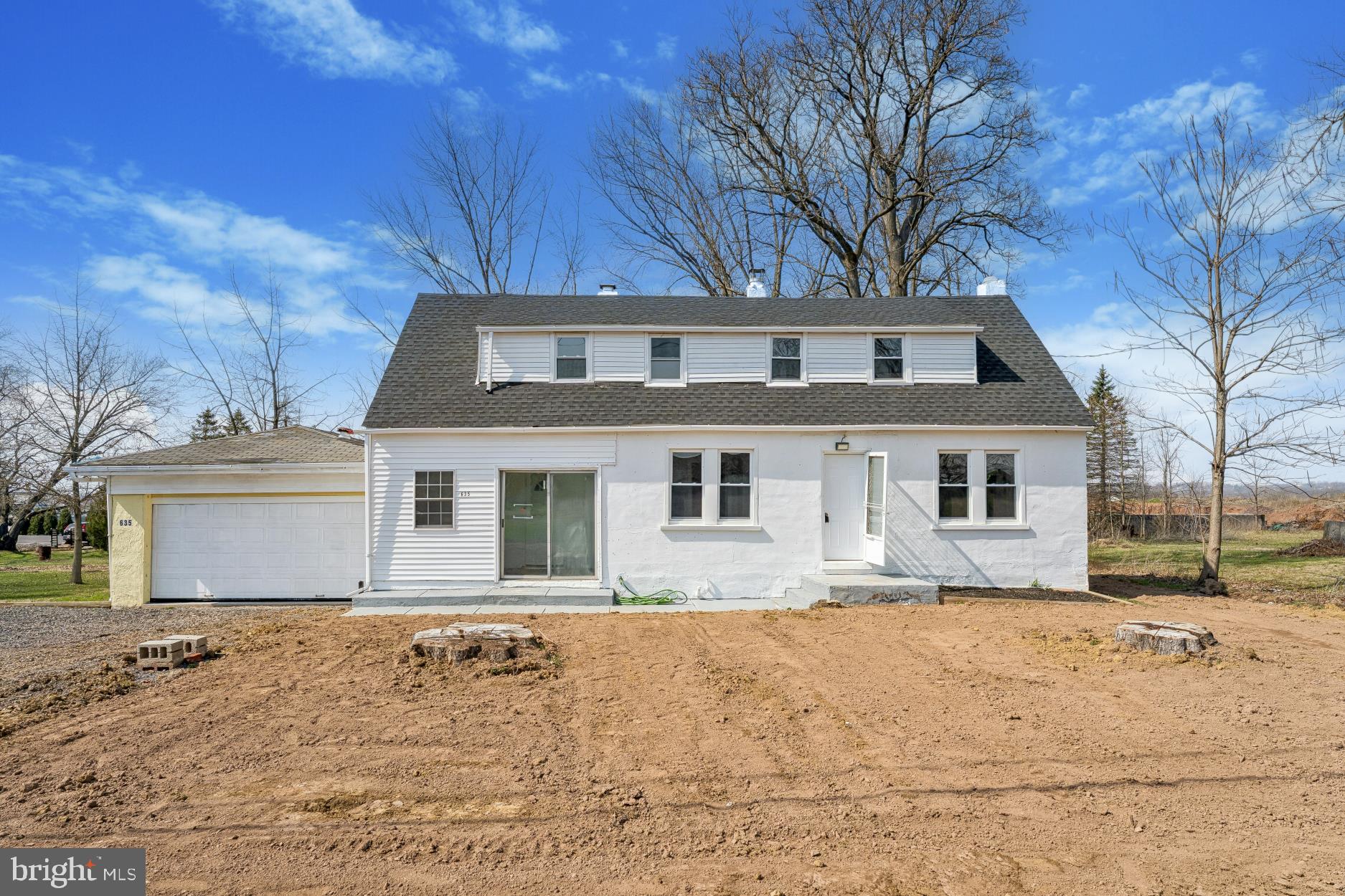 Welcome to 635 Elroy Road! Located in desirable Franconia Township and the Souderton Area School District, this beautifully renovated home offers the perfect blend of space, comfort and modern updates! This spacious 4 Bedroom, 2.5 Bath property has been thoughtfully updated throughout, making it truly move-in ready! Step inside to a bright and inviting Living Room featuring a cozy Fireplace - perfect for relaxing evenings at home. The heart of the home is the brand NEW, oversized Kitchen, designed with both style and functionality in mind, offering plenty of space for cooking, entertaining, and gathering. The main floor also features a Bedroom and NEWLY renovated Full Bath facilities! Completing the 1st Floor is a sunny enclosed porch, perfect for relaxation! There are an additional 3 Bedrooms and a NEW Powder Room. The full Basement offers a NEW French drain system and Bilco door.  NEW hot water heater. NEWLY connected to both Public Water and Sewer. NEW Roof, NEW electrical box and panel, most NEW vinyl clad replacement windows. NEW vinyl plank flooring and fresh paint throughout! Oil Furnace serviced in Feb. 2025.  The oversized Garage provides ample room for at least 4 cars plus additional storage areas, perfect for avid car enthusiasts/mechanics!  Outside, enjoy the very large yard - ideal for outdoor entertaining, gardening, or simply unwinding. The large rear yard contains a flag lot section which goes behind the neighbor's property (please refer to photo). Please excuse the current appearance of the yard -- grass seeding is in progress! :) With so many renovations completed throughout, this home offers peace of mind and stylish living in a great Souderton location. Don't miss your opportunity to make this great property your own!