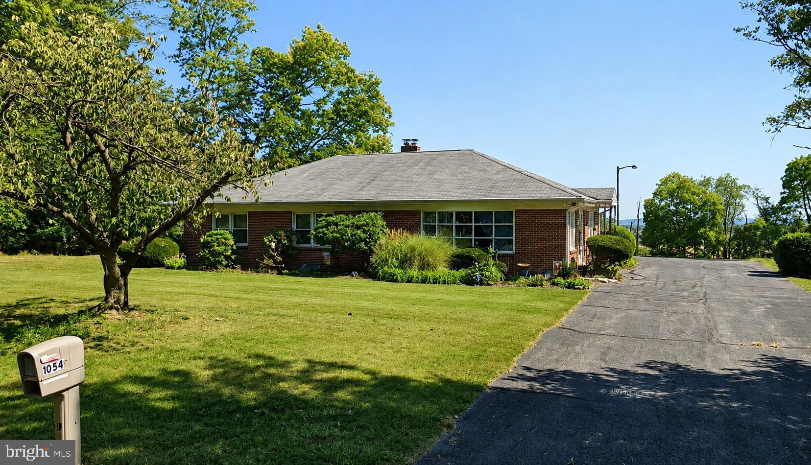 This property will be offered at Public Auction on 7/16 at 6:00 PM. The listing price is the opening bid only and in no way reflects the final sale price. 10% down due at auction, 2% transfer tax and 3% buyer's premium to be paid by the purchaser. Real estate taxes will be prorated.
 Opportunity awaits at 1054 Ridge Road, Elizabethtown, PA!
This solid brick ranch is situated on a beautiful 0.60-acre country lot and offers comfortable one-floor living with 3 bedrooms, 1.5 bathrooms and approximately 1,728 square feet of living space. The home features a spacious and functional floor plan, an inviting living area, a partially finished basement providing additional recreational or hobby space and an attached garage for added convenience.
Outside, enjoy the peaceful rural setting with plenty of room for gardening, outdoor entertaining or simply relaxing and taking in the surrounding countryside. Conveniently located just minutes from Elizabethtown, schools, shopping, restaurants and major commuter routes, this property offers the perfect blend of privacy and accessibility.
Whether you're looking for a primary residence, an investment opportunity or a home you can update and personalize, this property has tremendous potential. Don't miss your chance to purchase this well-maintained home. Bid online or live in person.