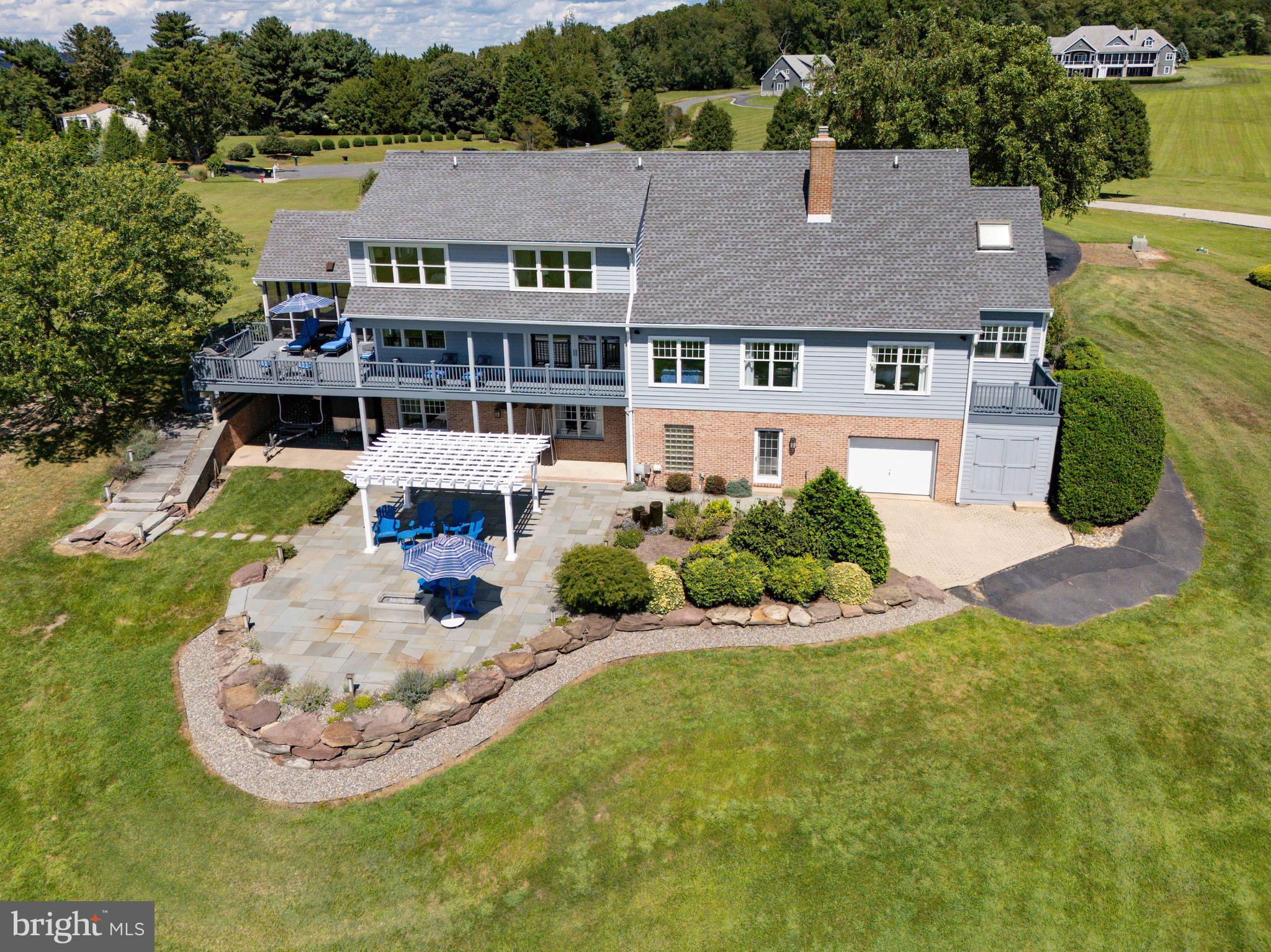 A Rare Waterview Masterpiece Designed for the Ultimate Boating Lifestyle.  Set on 1.376 acres with breathtaking water views and unforgettable sunsets, this one-of-a-kind contemporary residence delivers luxury, functionality, and resort-style living at every turn. Thoughtfully designed with the boater in mind, this exceptional home offers expansive entertaining spaces, refined finishes, and outstanding access to boating amenities.  The main level showcases a dramatic living room with gas fireplace and sweeping water views, a dining room opening to the rear deck, and a stunning gourmet kitchen featuring quartzite countertops, a grand center island, Wolf 5-burner gas stove, steam oven, convection oven, butler’s pantry, and an additional pantry/storage area with refrigerator. A screened-in porch just off the kitchen creates the perfect space for relaxed water view living.  Also on this level are a hall bath, office or sitting room, main-level laundry, and a luxurious primary ensuite with small deck with stunning views, double vanities, jetted tub, and a separate shower and toilet area.  The second level is ideal for hosting, offering three bedrooms with 2 full baths, plus two additional sleeping areas thoughtfully designed for guests.  The fully finished lower level continues the luxury with a gym, room of choice office/bedroom with full bath, additional laundry hookup, spa-like bathroom with double vanities and an oversized shower, and a rear entry perfectly suited for coming in off the water.  Outdoor living is nothing short of spectacular, featuring a professionally landscaped rear patio with water feature, firepit, garden irrigation, and automatic timers. A rear garage and workshop provide ample space for water toys, gear, and golf carts.  Additional highlights include a deeded boat slip with two boat lifts, 90-amp electric vehicle charger, whole-house humidifier, three-zoned HVAC, Pella windows, architectural roof (2024), automatic water shutoff system (Flow Logic), and all appliances included.  An exclusive opportunity to acquire the adjacent 1.245-acre parcel, offered separately, featuring a deeded boat slip and lift, with right of first refusal extended to the purchaser.  This extraordinary property offers a rare blend of luxury, privacy, and elevated water view living. Truly one of a kind—schedule your private showing today.