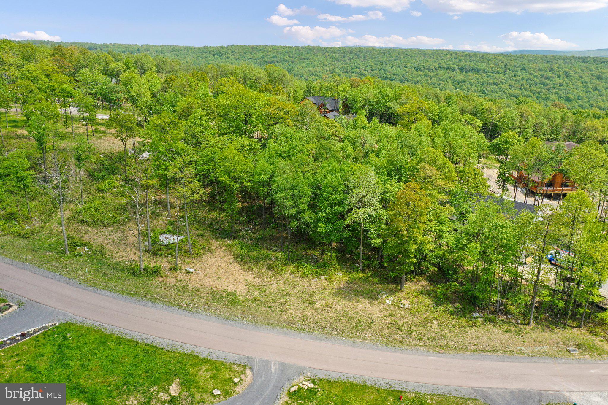 Beautiful 1/2 acre lot in the North Camp Ridge section of the exclusive and gated North Camp Community with spectacular mountain views! Bring your own builder, or use ours! Public water and sewer hookups are available! High-speed internet is available in the community!  Low HOA fee covers common area maintenance, snow removal and road maintenance, and walking trails!  ** Note, this listing is for the lot only.