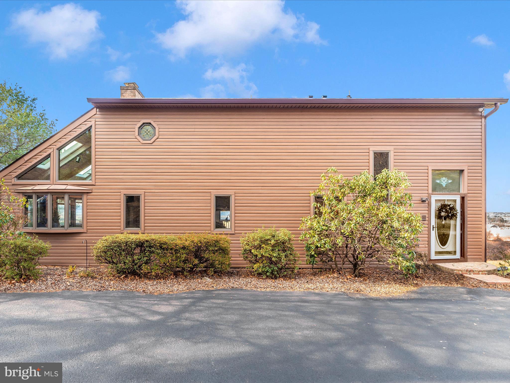OFFER DEADLINE FRIDAY @6PM***Don't miss out on this adorable contemporary home with true million dollar views of Middletown valley! This  cozy home has a unique enclosed foyer with vaulted ceiling that then enters into the sunken formal living or dining room (your choice) with amazing view from the large windows that adorn the rear facing wall. To the left of the entryway is the ceramic tiled floor hallway that leads to the open staircase to upper and lower levels, a half bath, the cozy kitchen, inviting family room with brick fireplace, vaulted ceiling, slider to rear deck, and the enclosed sun room off the far side of the house. The views are like no other, you don't find true panoramic views like this every day! The upper level has 3 bedrooms and 2 full baths. There is a large full basement that is unfinished but could easily finished off to be a great rec room with full bath (rough in is already there), and there is a level walk out to the rear yard. The long time owner has lovingly maintained this home with a new roof and skylights in April, furnace and hot water heater only 2 years old. Just needs a little updating or even an addition for those buyers really wanting this view but a bigger home, the possibilities are endless!