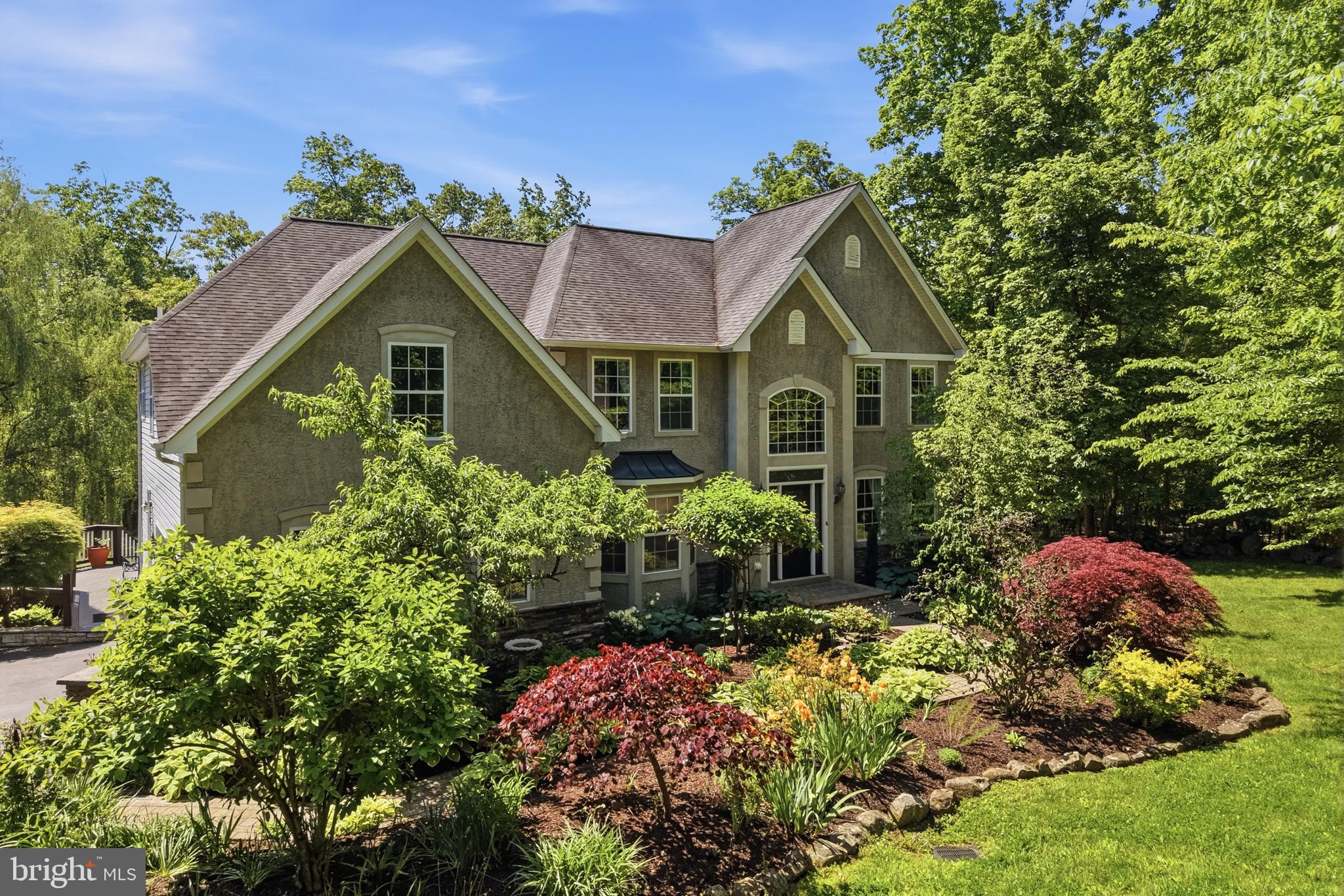 This Neo-colonial home is nestled on 5.75 partially wooded acres. It balances timeless, symmetrical architectural styling with modern spacious living in a private park-like setting. It offers the stately curb appeal of a colonial estate with abundant distance between neighbors but close to everything you need.
As you wind down the long-paved driveway you will immediately be impressed with its great curb appeal enhanced by the well planned and maintained landscaping featuring  many perennial plantings and specimen trees. A paver walkway leads to the impressive central entrance door.
This center hall plan opens into a dramatic two-story foyer with sparkling hardwood floors and overlooking balcony. Directly to the right is a large formal living room/den. It also boasts of hardwood floors. To the left of the foyer is an elegant formal dining room. It's the ideal place for your family holiday meals. The central focus of the first floor is the large eat in kitchen and adjoining two story family room.
Just imagine hosting parties here or just enjoying time with the family. The kitchen has ample oak cabinets, hard surface counter tops, stainless steel appliances, pantry and a bright and cheery breakfast nook. 
Relax in the adjoining two-story family room and watch a movie or your favorite team play a game. It has a warm and inviting fireplace for those cold winter nights. Also, for those who work from home there is a cozy den/office/library located on the first floor. 
Additionally, there is a very convenient first floor bath with a shower. 
You will fall in love with the expansive rear deck that you gain access to off the kitchen. It has been replaced with composite deck material for ease of maintenance and can host a large family gathering for those special occasions. It directly overlooks the private rear yard. The owner has added an awning for those hot summer days.
Adjourn to the second floor to the large master bedroom suite. It features a volume ceiling, luxurious master bath and a very convenient walk-in closet and a large multipurpose sitting room / exercise room. 
Additionally, there are three bedrooms all of ample size and a full hall bath with a tub/shower.  The very well-designed balcony overlooks the family room and two-story foyer.
The full basement has been partially finished providing a great rainy day play area for the kids. Also, the unfinished portion is ideal for storage or a workshop or hobby area.
Attached to the home is an oversized two car garage. The floor has been painted with epoxy resin paint for a sharp clean look and ease of maintenance.
The private rear yard is partially wooded and boasts of an established fenced vegetable garden. It’s ready for your plantings as we speak. Additionally theres a green house to start your plants.
A very impressive addition to the home is the custom built two car detached garage. It will provide a perfect place for your hobby cars and yard tools. The second floor is finished into a large workshop.
Oh, and don't miss the koi pond as you walk between the house and garage. It adds a very soothing effect to the home and features aquatic plantings as well as a few fish.
This private hideaway is just minutes to the quaint Skippack Village, Spring Mount ski area, the Perkiomen trail system, Philadelphia Premium Outlets and major highways like Route 422 the Pa. turnpike and Route 476.
Hurry out and make this home yours. It awaits your personal touches.